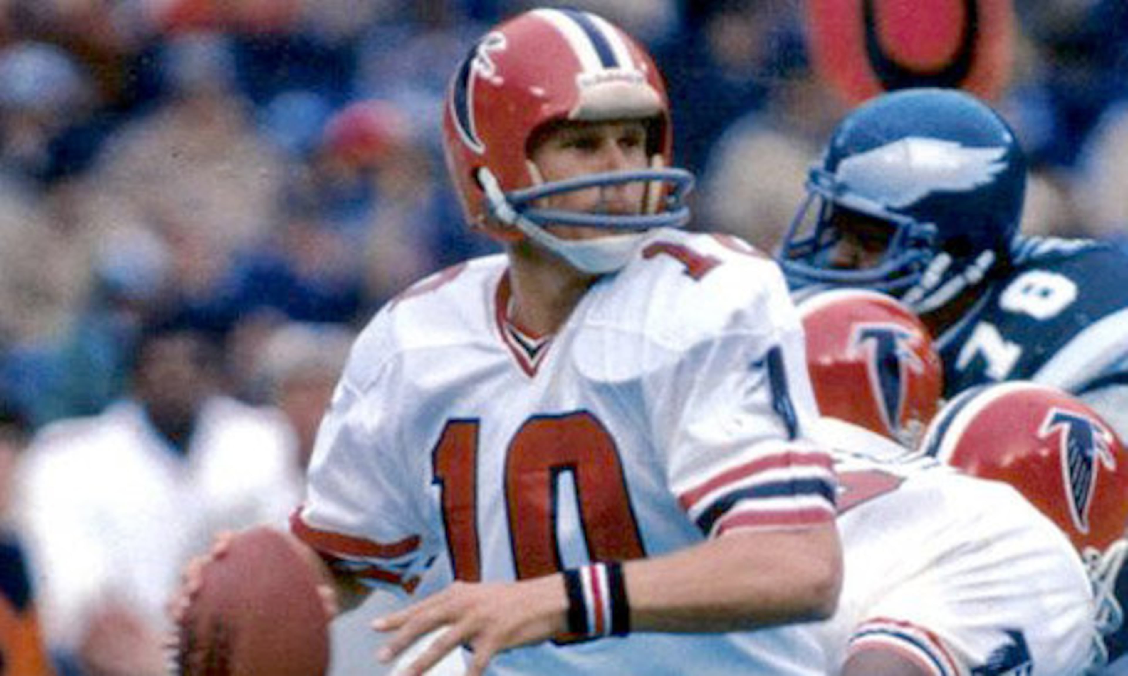 The Atlanta Falcons debuted with red helmets with a black falcon crest logo, center black stripe surrounded by two gold stripes and two white stripes. (AJC file photo)