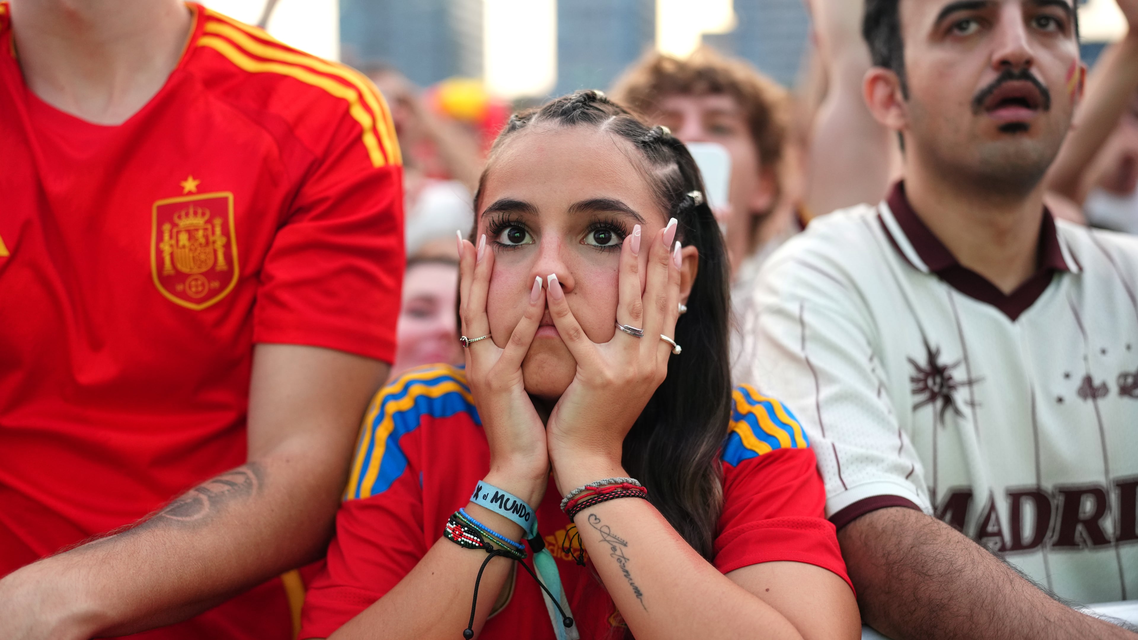 Spanish fans react while watching the World Cup final soccer match between Spain and Argentina on giant screens in Barcelona, Sunday, July 19, 2026. The match is being played in East Rutherford, N.J., near New York. (AP Photo/Joan Mateu Parra)