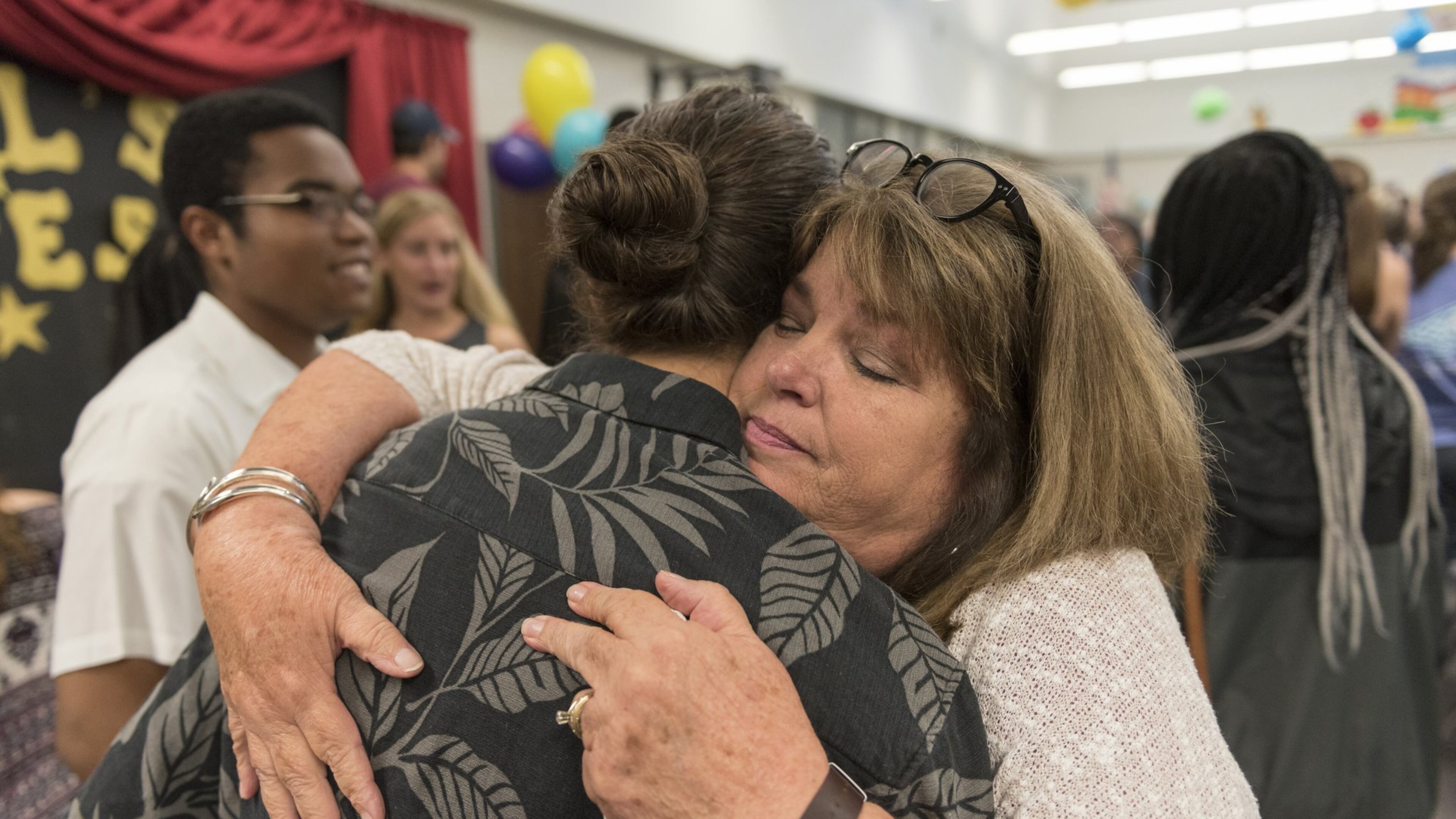 Trisha Hardin, a first grade teacher at McCall Primary School, hugs her former students during a visit from seniors from North Cobb High School as they talk about their time at McCall Primary School in Acworth on Tuesday, May 23. Hardin taught many of the visiting students and has been teaching in Cobb County for 18 years and plans to retire at the end of this year. When asked about her time in the classroom, Hardin said, “I wanted to teach children that they could be anything they wanted to be,” and that teaching “gives life purpose.” Students who were in the first class to attend McCall Primary in 2005 visited their past teachers to express their gratitude before going off to college. (DAVID BARNES / DAVID.BARNES@AJC.COM)