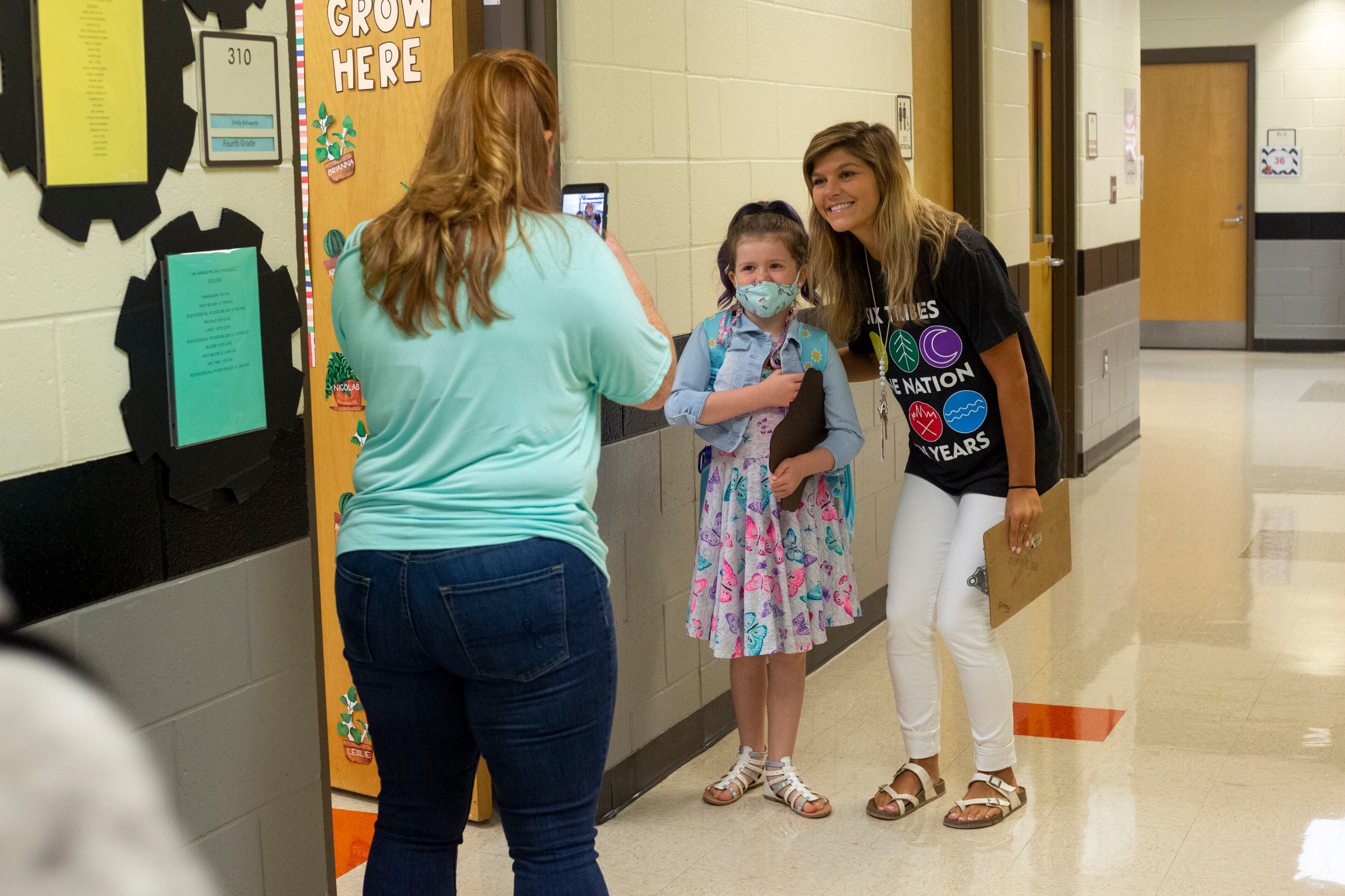 Whitney Fearon takes a photo of her daughter Elise (9) and her teacher Ms. Emily Ashworth on the first day of school at Clark Creek Elementary School in Acworth, Georgia, on August 2, 2021. (Rebecca Wright for the Atlanta Journal-Constitution)