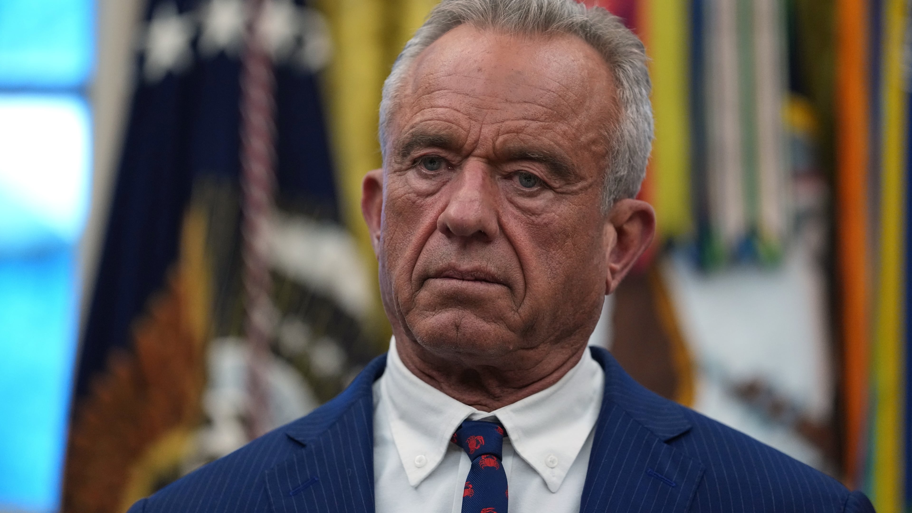 Health and Human Services Secretary Robert F. Kennedy Jr. listens as President Donald Trump speaks at an event on addiction recovery in the Oval Office of the White House, Thursday, Jan. 29, 2026, in Washington. (AP Photo/Allison Robbert)