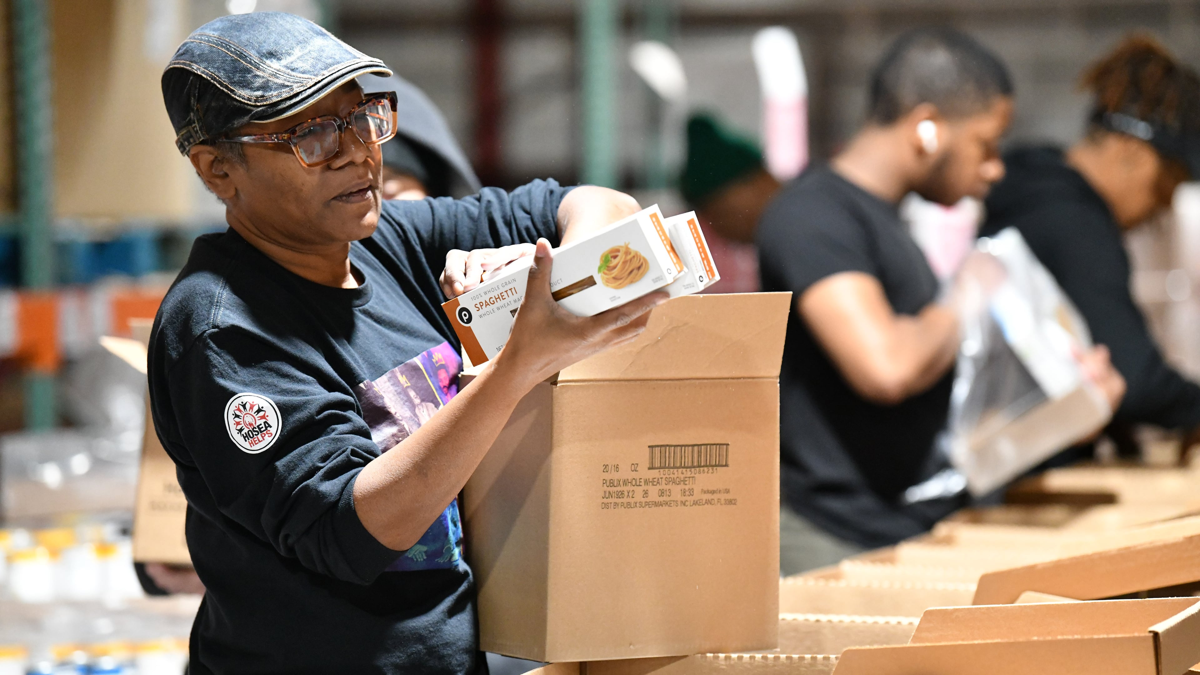 Volunteers including Naneke Brooks prepare meal kits for the big Saturday give away at Hosea Helps, Friday, November 22, 2024, in Atlanta. “Thanksgiving” at Hosea Helps will begin on Saturday when they distribute 500 meal kits to families consisting of a turkey, with all the sides and beverages. Elisabeth Omilami, president of Hosea Helps, said allowing families to go home and cook their meals will give them a sense of dignity. (Hyosub Shin / AJC)