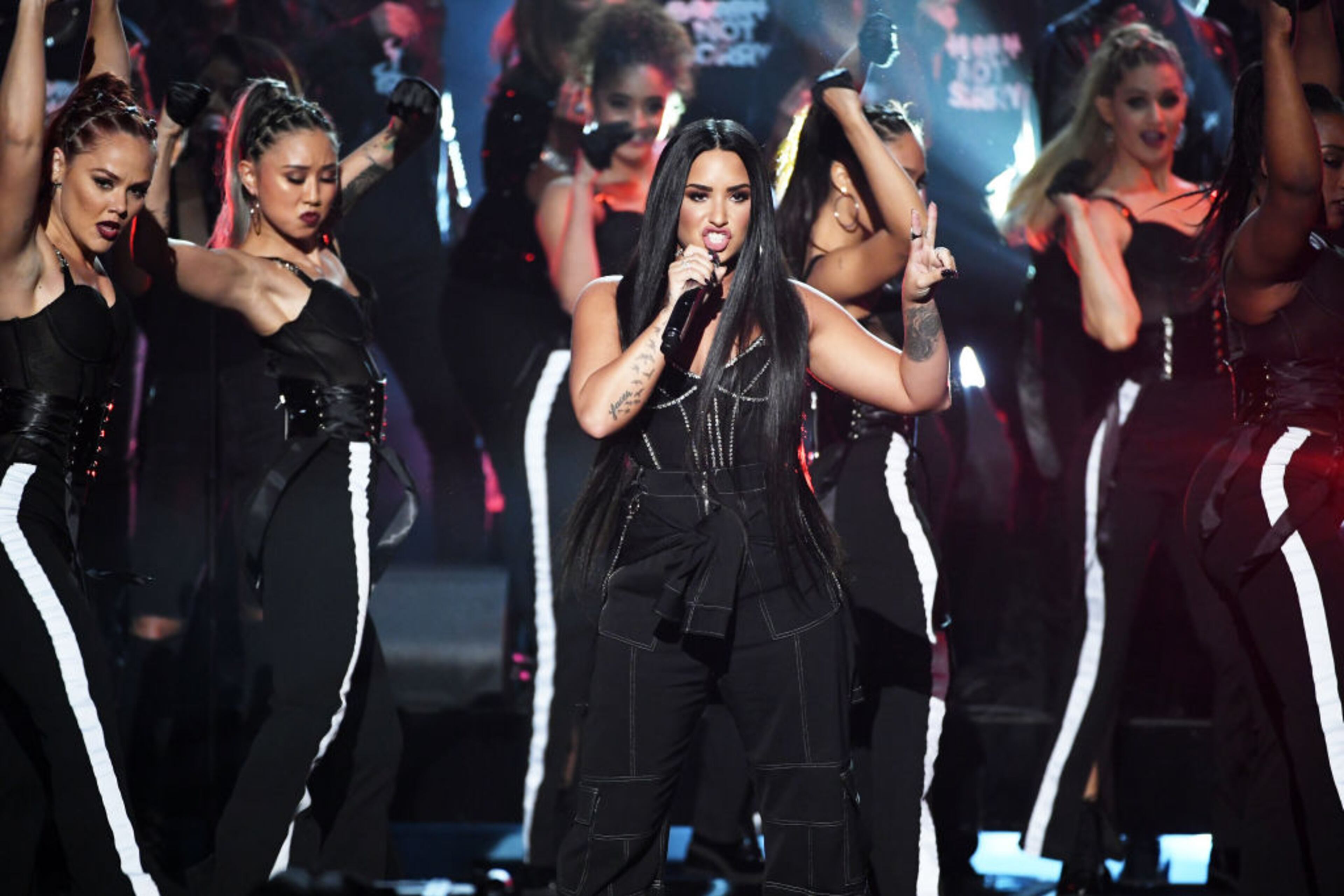 LOS ANGELES, CA - NOVEMBER 19: Demi Lovato (C, holding microphone) performs onstage during the 2017 American Music Awards at Microsoft Theater on November 19, 2017 in Los Angeles, California. (Photo by Kevin Winter/Getty Images)