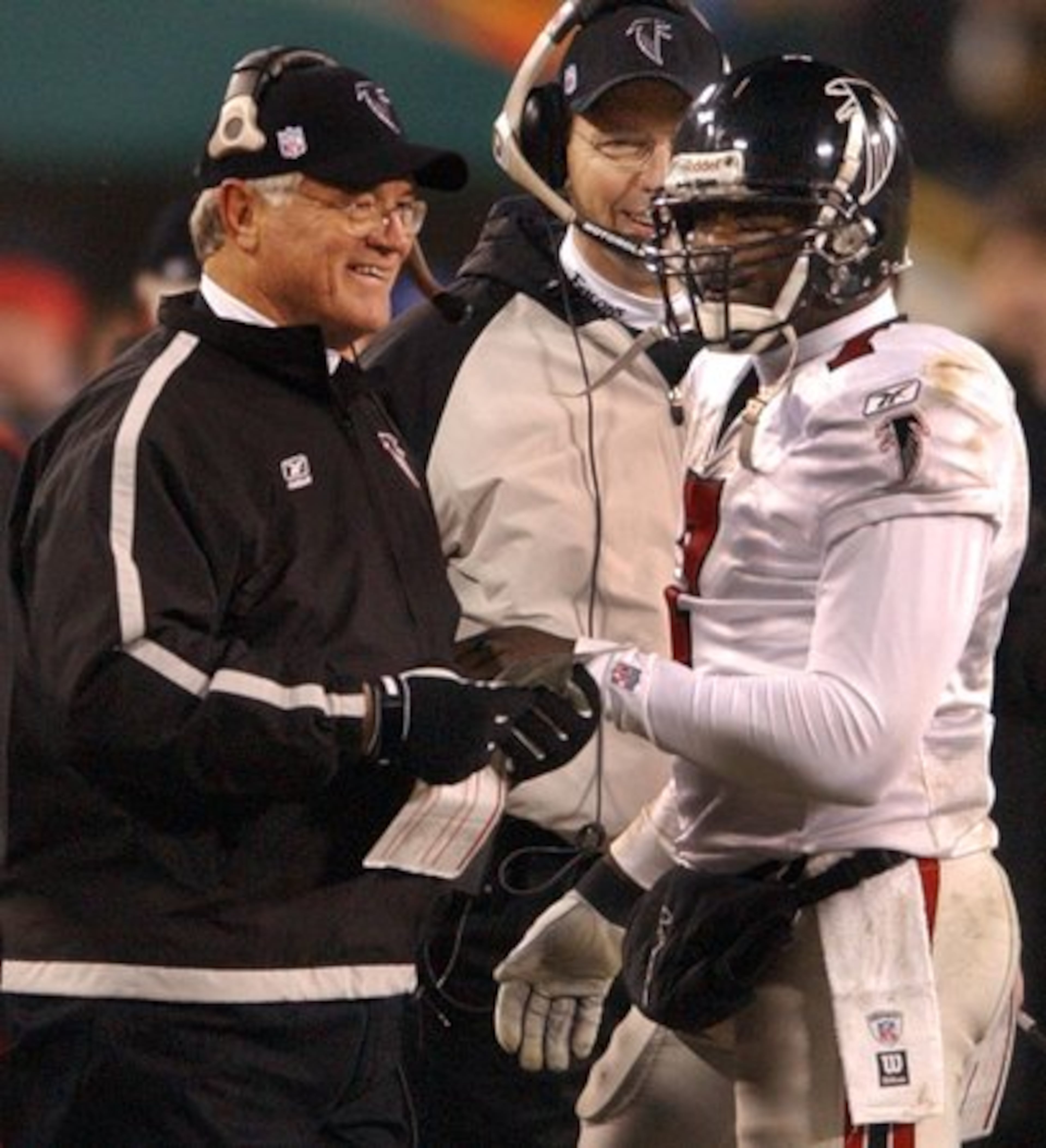 Falcons head coach Dan Reeves smiles on the sidelines with quarterback Michael Vick just after the Falcons took a 21-0 lead in the first half of the game.