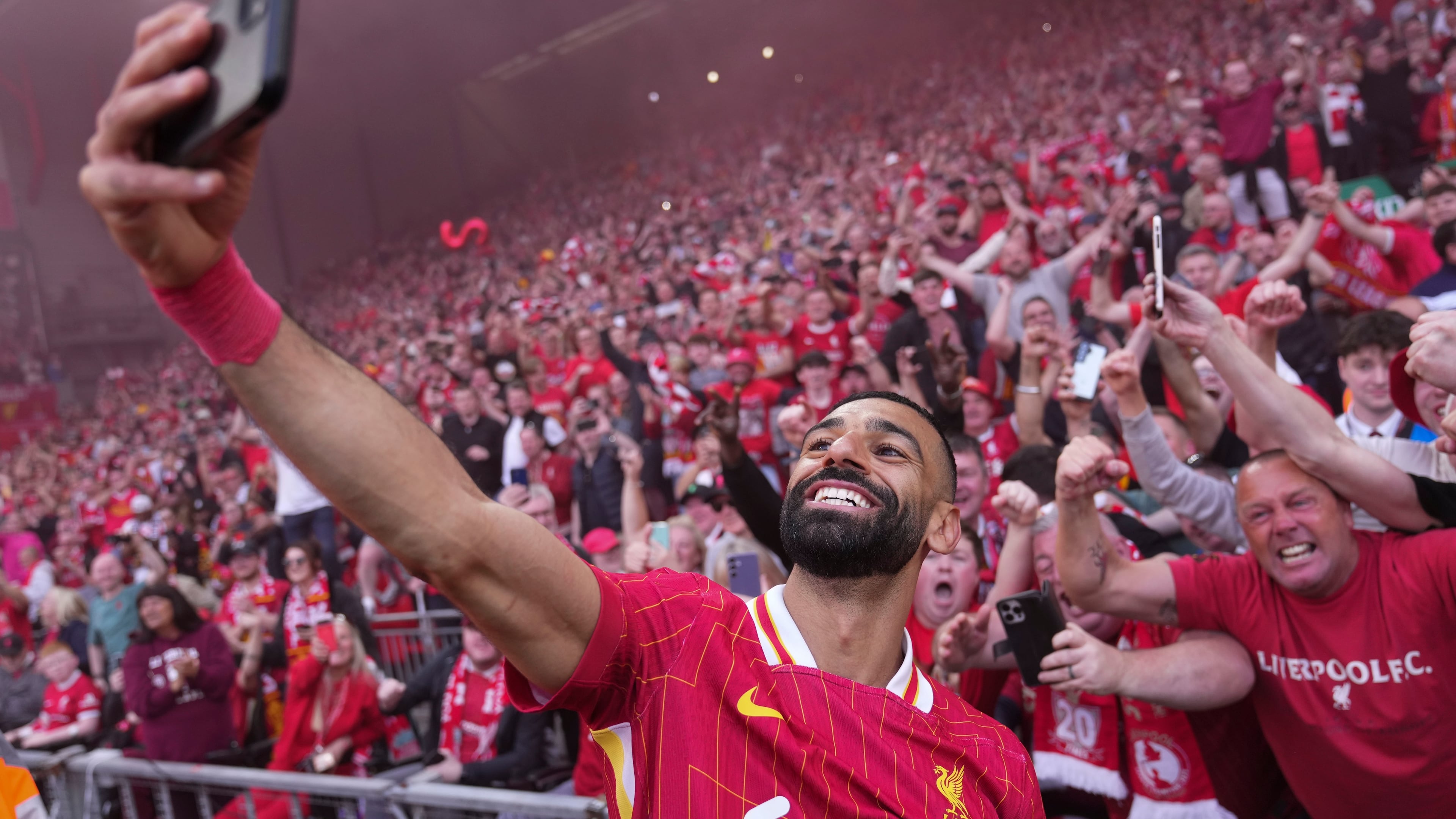 FILE - Liverpool's Mohamed Salah celebrates by taking a selfie after winning the English Premier League soccer match between Liverpool and Tottenham Hotspur and clinching the Premier League title at Anfield in Liverpool, England, April 27, 2025. (AP Photo/Jon Super, File)