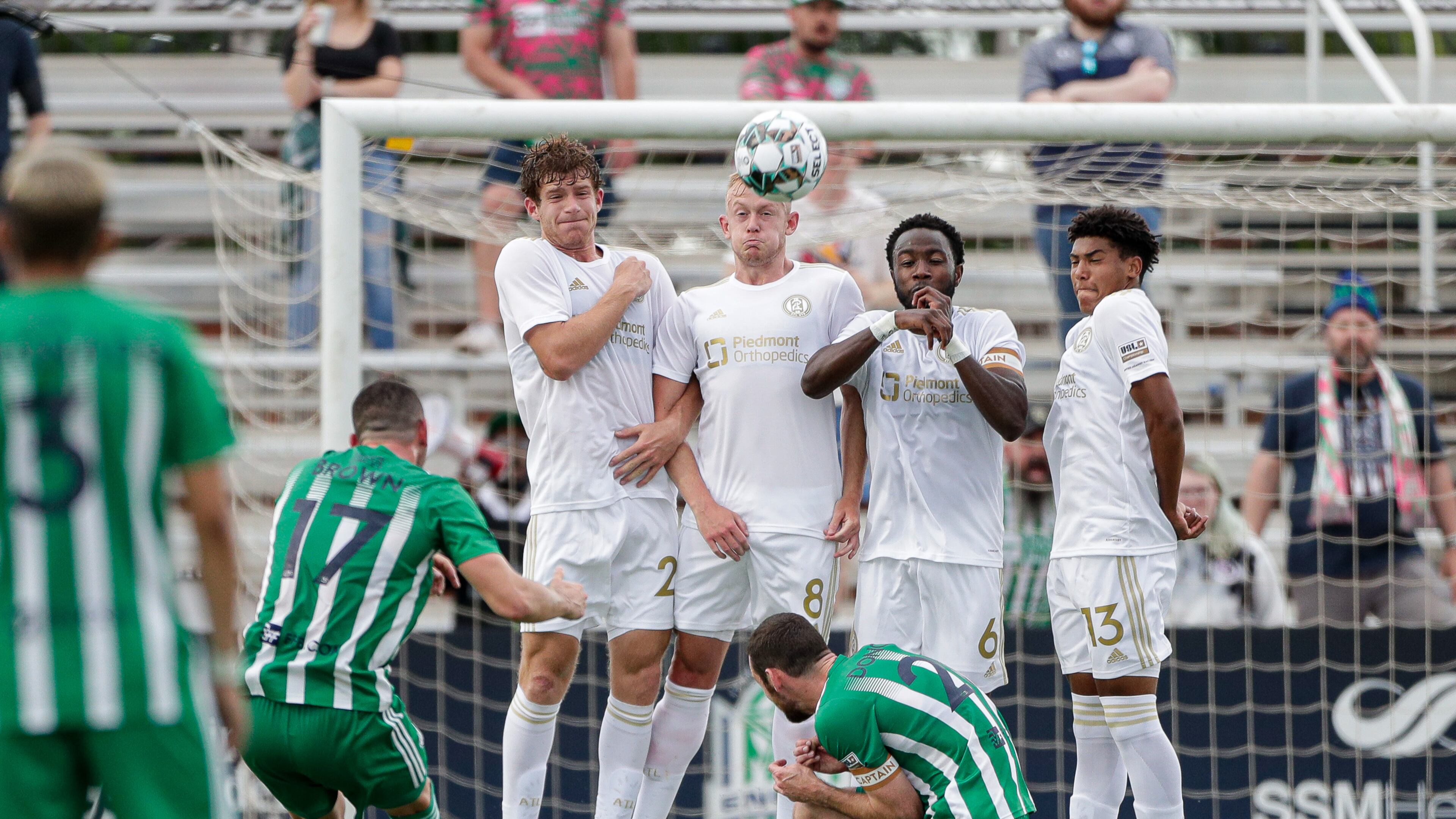 A wall comprised of Atlanta United 2's Aiden McFadden (2), Chris Allan (8), Bradley Kamdem Fewo (6) and Caleb Wiley (13) attempt to block a penalty kick by Oklahoma City Energy's Jonathan Brown (17) during a USL Championship match Sunday, May 16, 2021, at Taft Stadium in Oklahoma City, Okla.