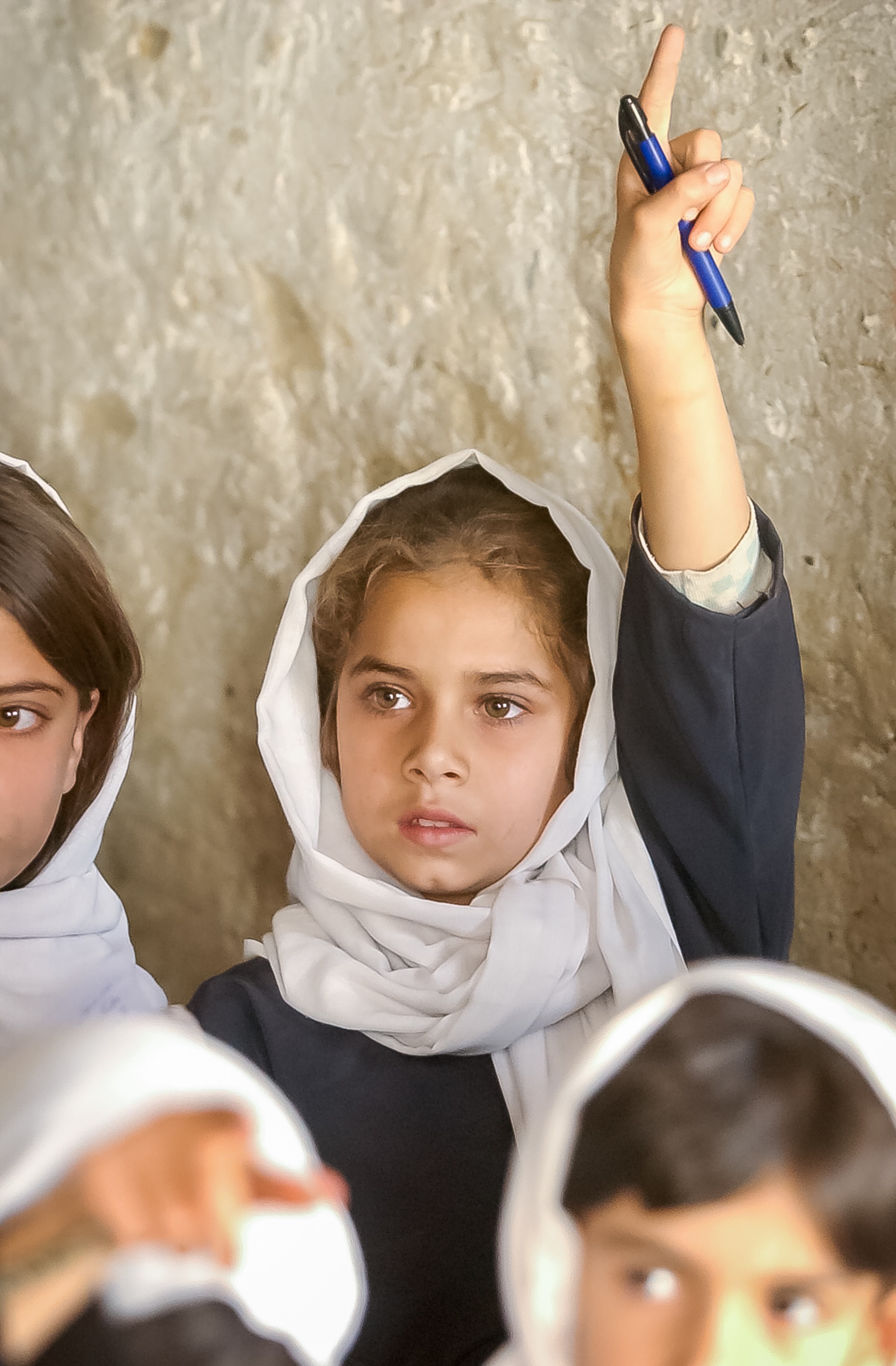 KABUL, AFGHANISTAN: Third-grader Omaira, 9, raises her hand to answer a question at the Naswan Manochary girls' school in Kabul Sunday, Sept. 15, 2002. (Bita Honarvar / The Atlanta Journal-Constitution)