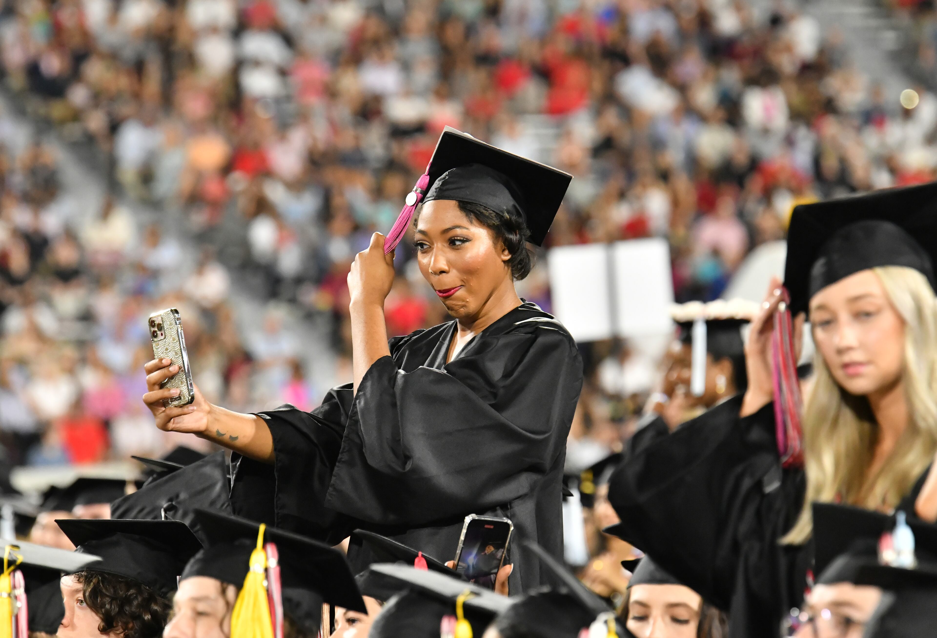 UGA graduates move their tassels during the 2022 Spring Undergraduate Commencement at Sanford Stadium in Athens on Friday, May 13, 2022. (Hyosub Shin / Hyosub.Shin@ajc.com)
