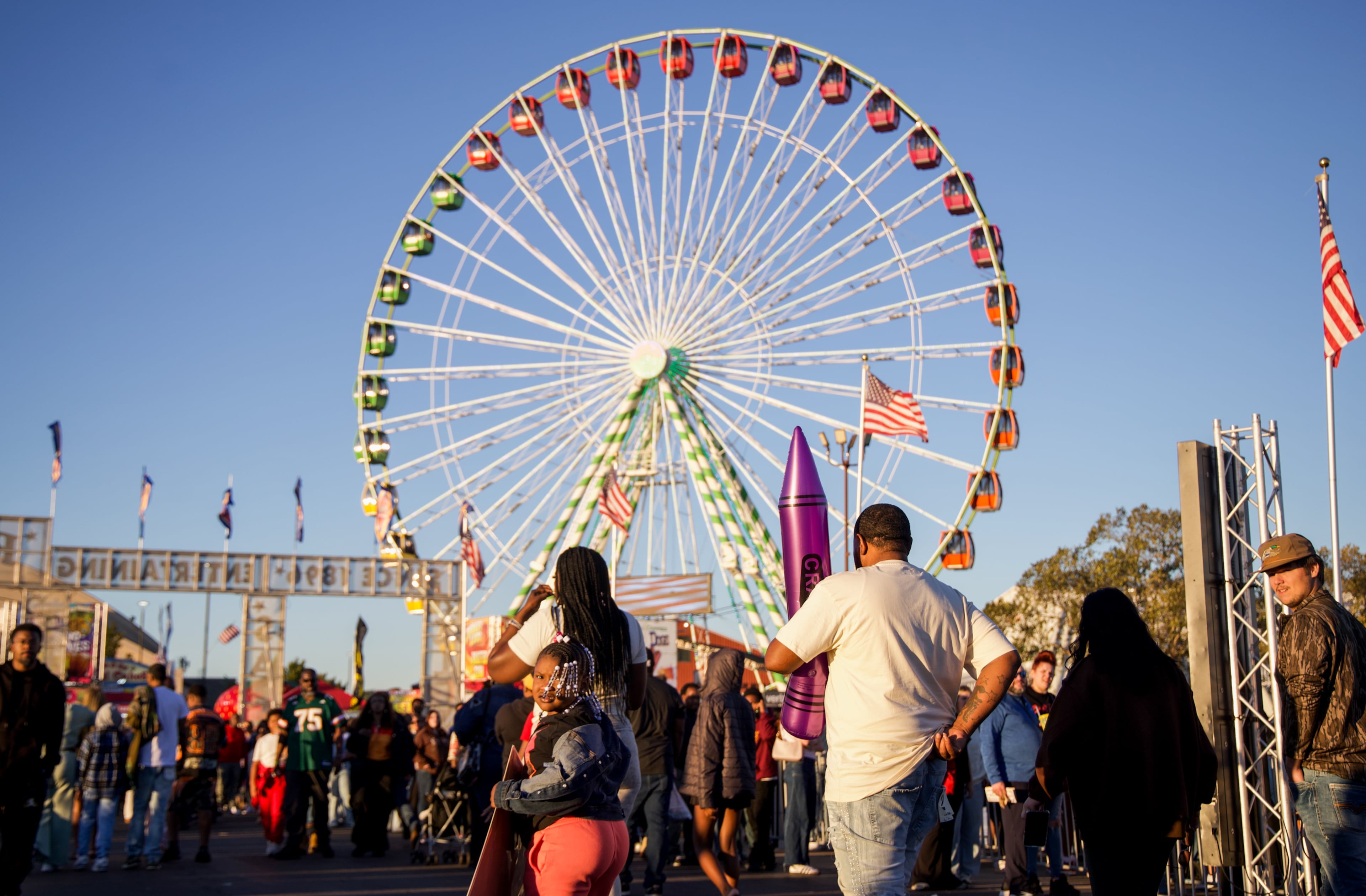 Fairgoers walk around at the Georgia National Fair in Perry, Georgia, on Oct. 17, 2026. The fair ran from Oct. 8 to Oct. 18, featuring rides, games, concerts, shows, and livestock competitions. (Emily Laycock/UGA Photojournalism Workshop)
