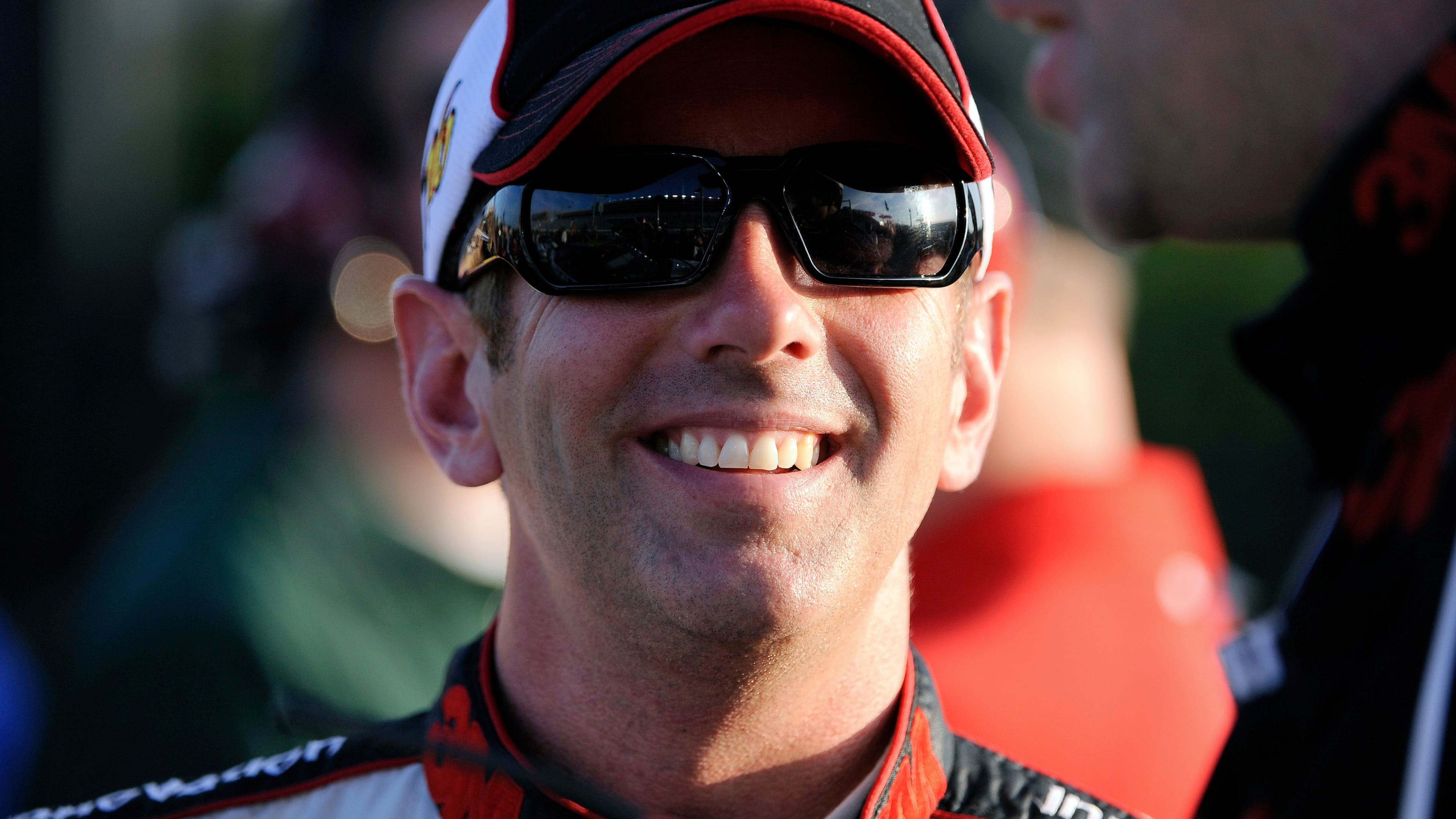 FILE - Greg Biffle smiles along pit row during qualifying for Sunday's NASCAR Sprint Cup Series auto race at Atlanta Motor Speedway, Friday, Aug. 31, 2012, in Hampton, Ga. (AP Photo/David Tulis, File)