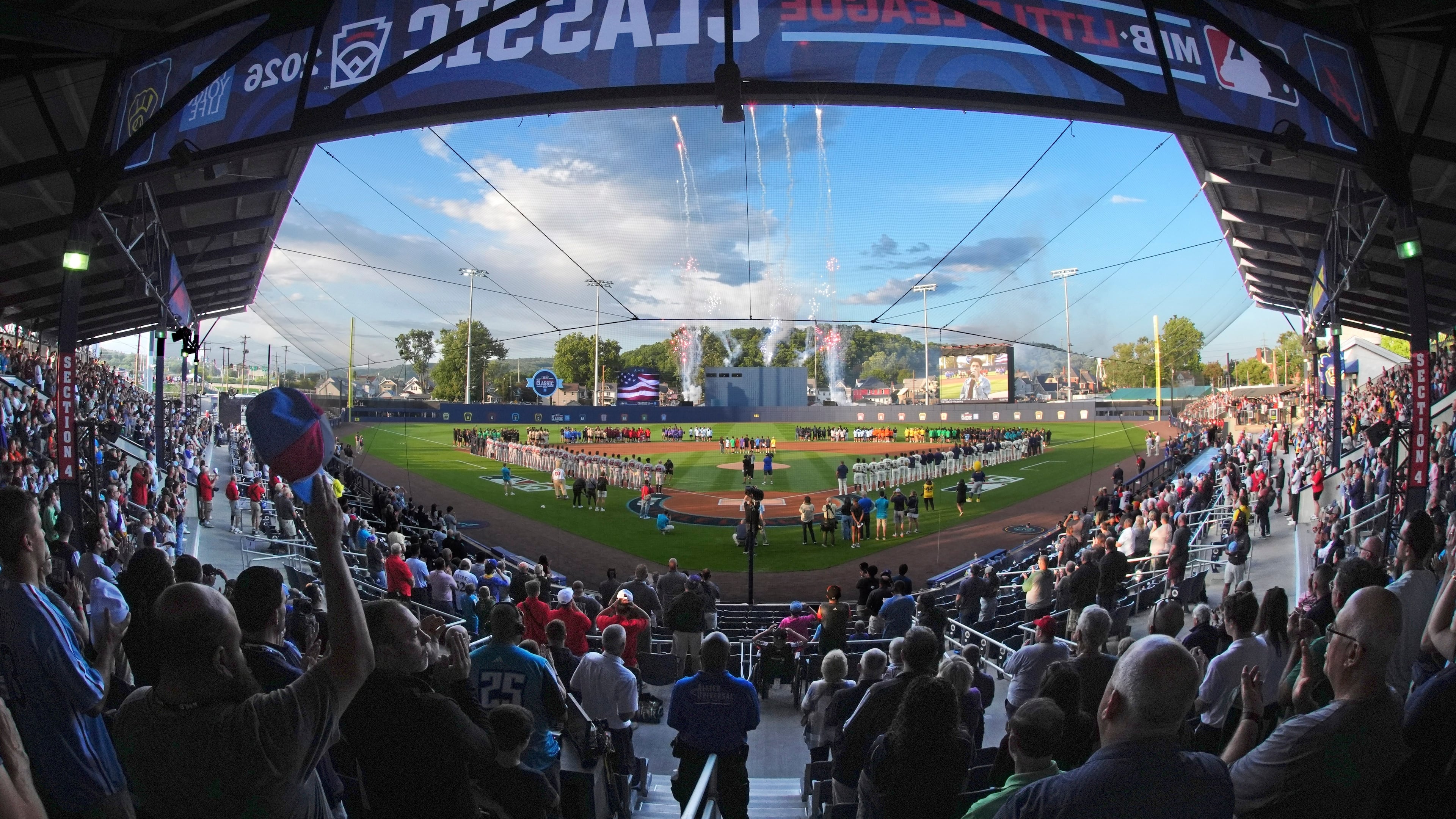 In this photo taken with a fisheye lens, fans fill the ballpark for the opening ceremony before the Little League Classic baseball game between the Milwaukee Brewers and the Atlanta Braves at Bowman Field in Williamsport, Pennsylvania on Sunday, Aug. 23, 2026. (Gene J. Puskar/AP)