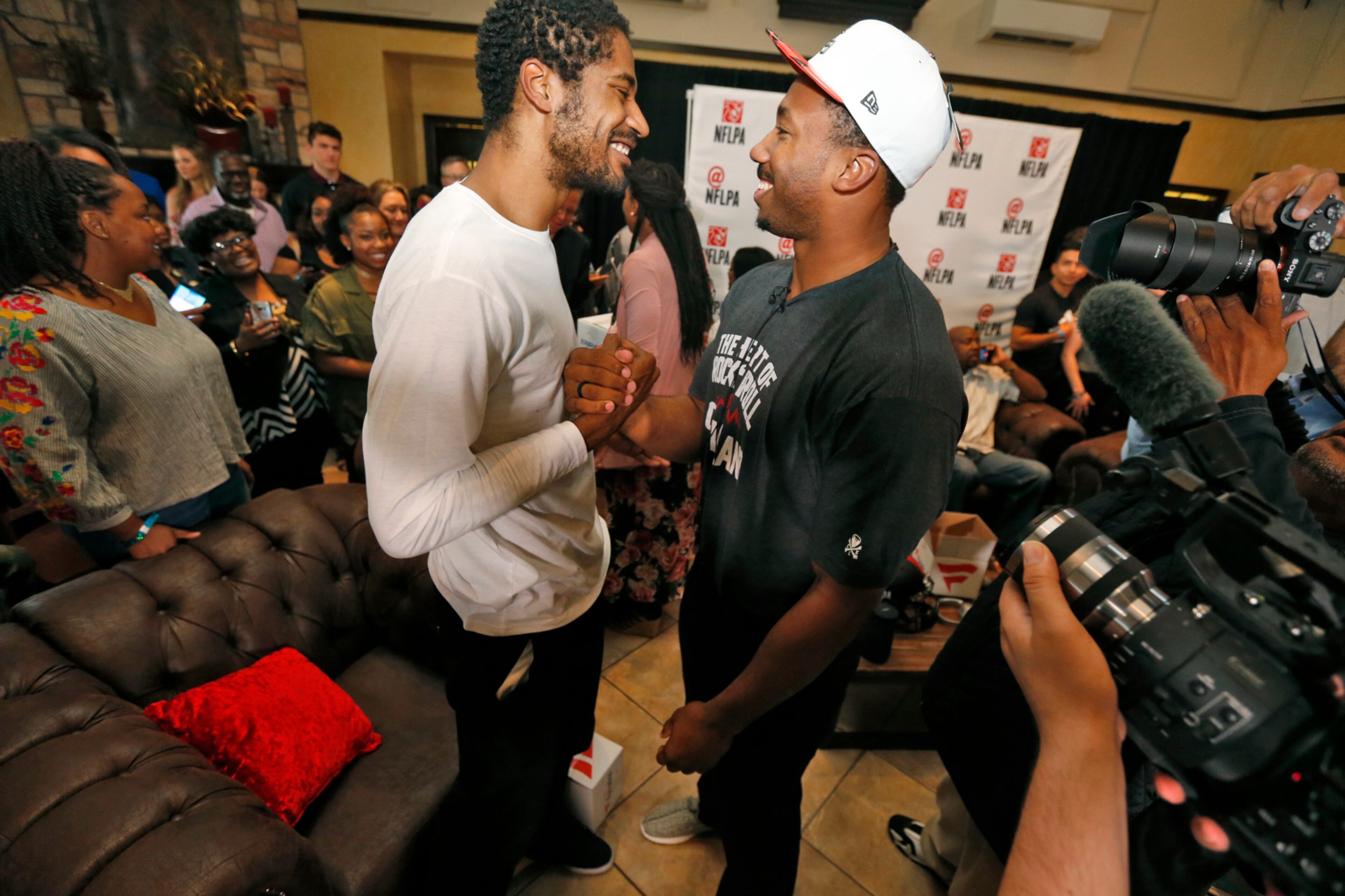 Texas A&M's Myles Garrett, right, is congratulated by his brother and former NBA player Sean Williams after the Cleveland Browns selected Garrett with the No. 1 pick in the NFL football draft, at Terre Verde Golf Course in Arlington, Texas, Thursday, April 27, 2017. (Nathan Hunsinger/The Dallas Morning News via AP)