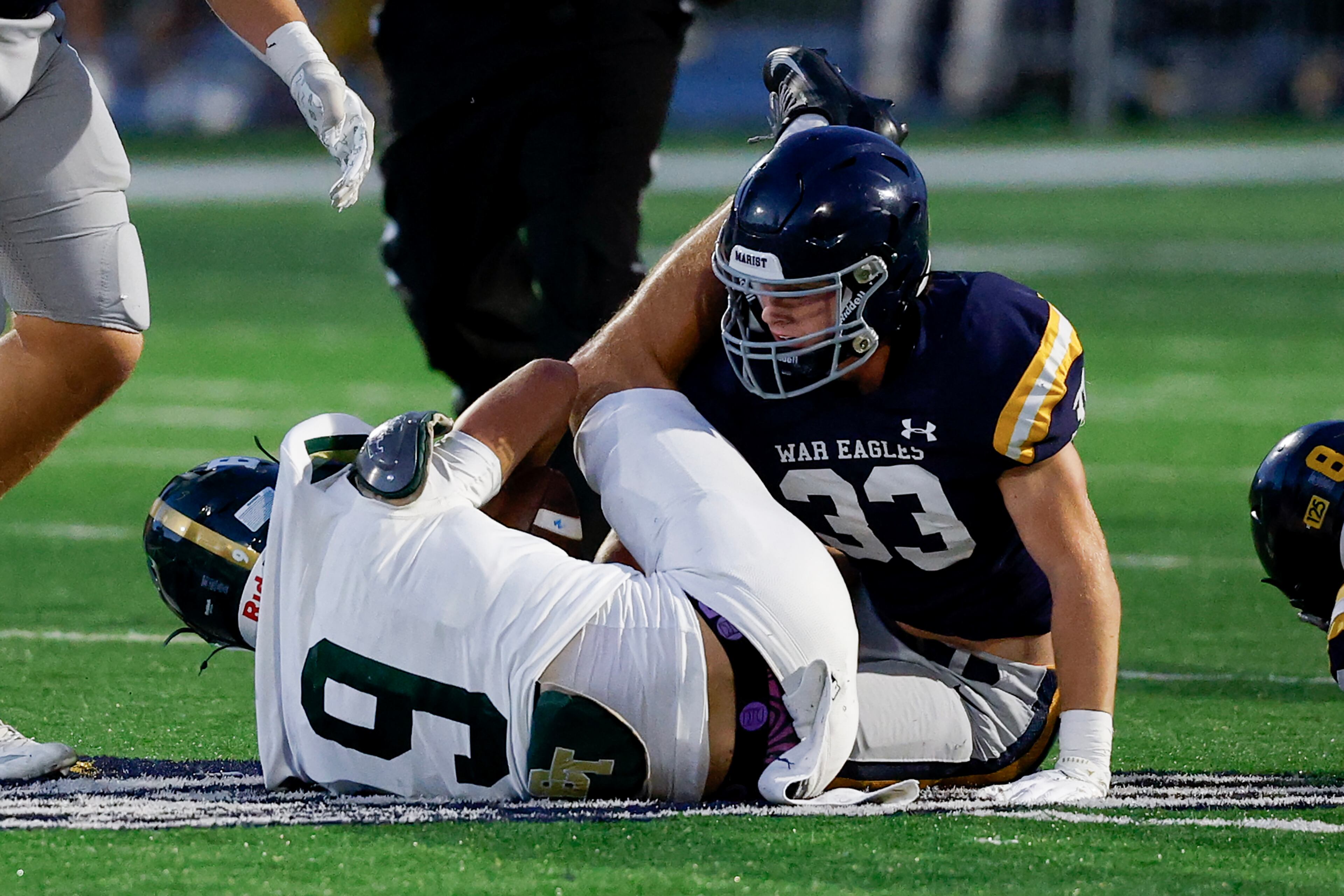 Marist's Jack Weeks (33) stops Blessed Trinity's Quinn Smith (9) during the first half a high school football game between Blessed Trinity and Marist, Friday, Sept. 25, 2026, in Atlanta. (Erik S. Lesser for the AJC)