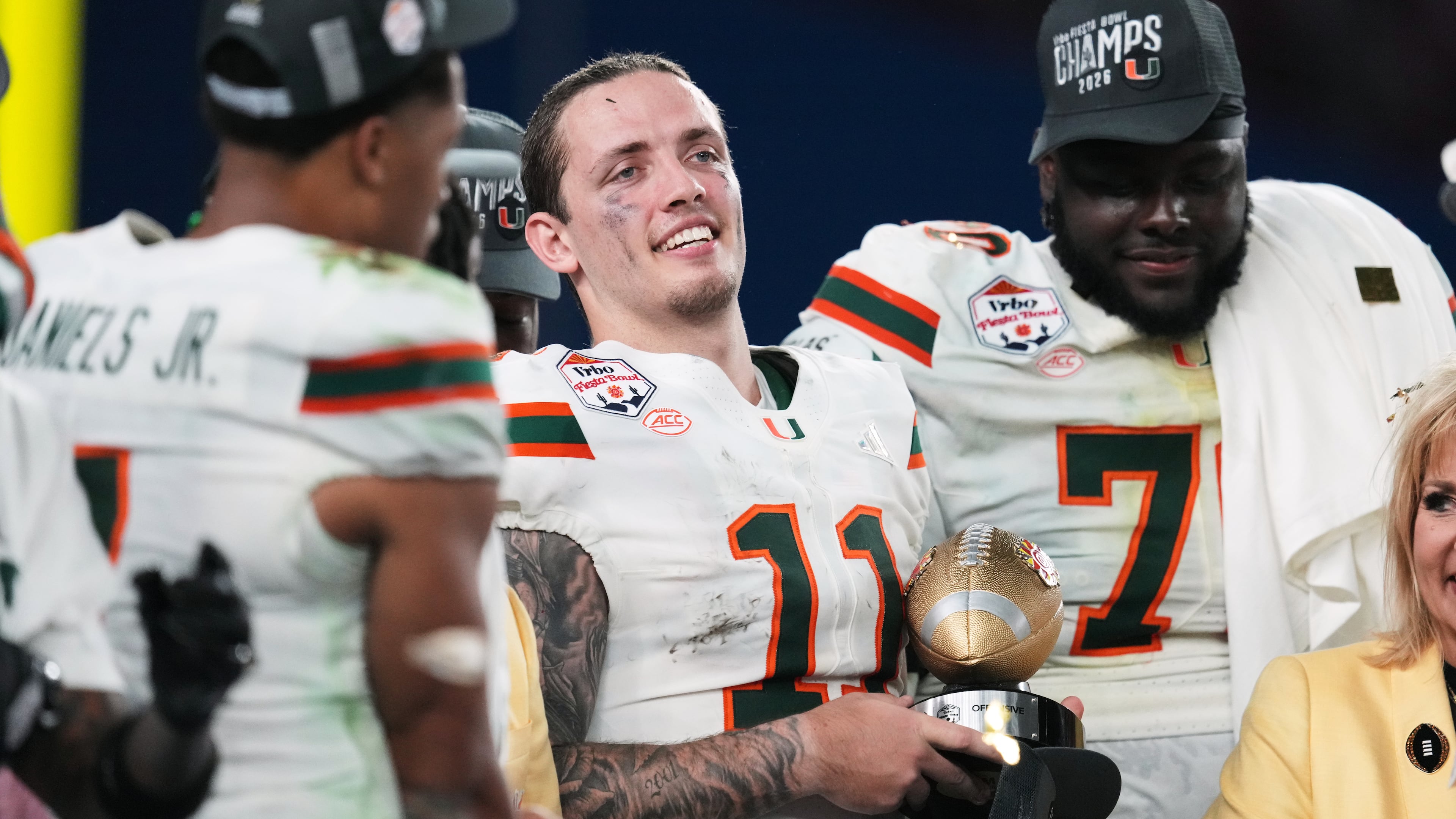 Miami quarterback Carson Beck (11) holds the offensive player of the game trophy after winning the Fiesta Bowl NCAA college football playoff semifinal game against Mississippi, Thursday, Jan. 8, 2026, in Glendale, Ariz. (AP Photo/Ross D. Franklin)