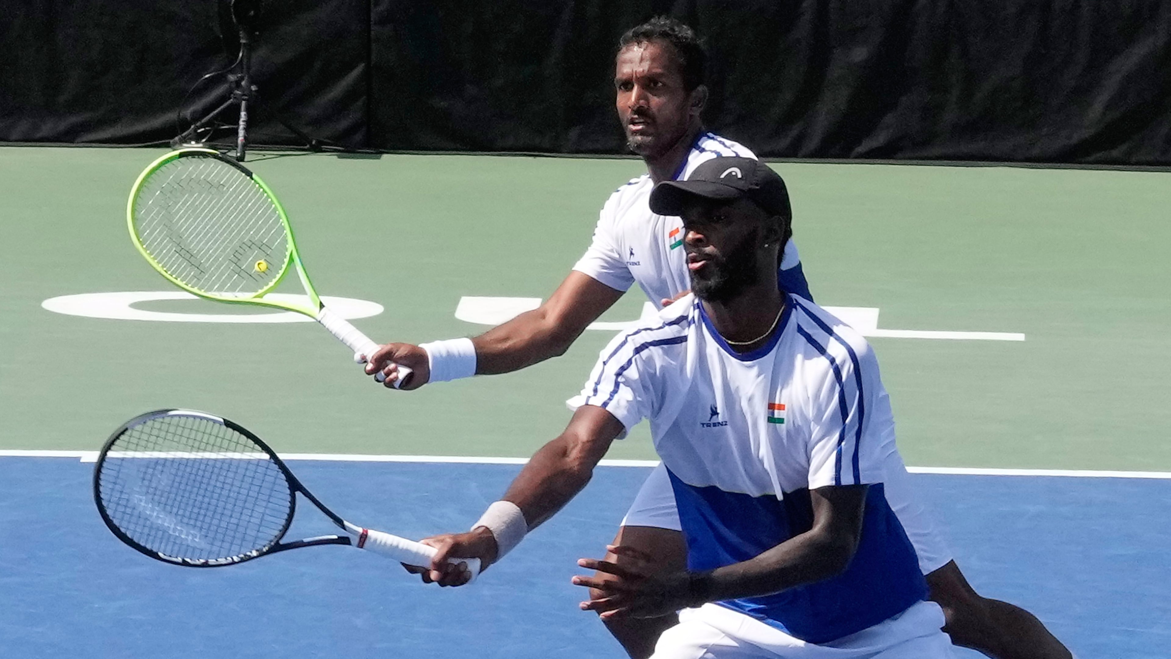 India's Dhakshineswar Suresh, front, returns the ball as his teammate N Sriram Balaji watches during a double match of a Davis Cup World second-round qualifier against South Korea's Nam Jisung and Park Uisung in Seoul, South Korea, Saturday, Sept. 19, 2026. (AP Photo/Ahn Young-joon)