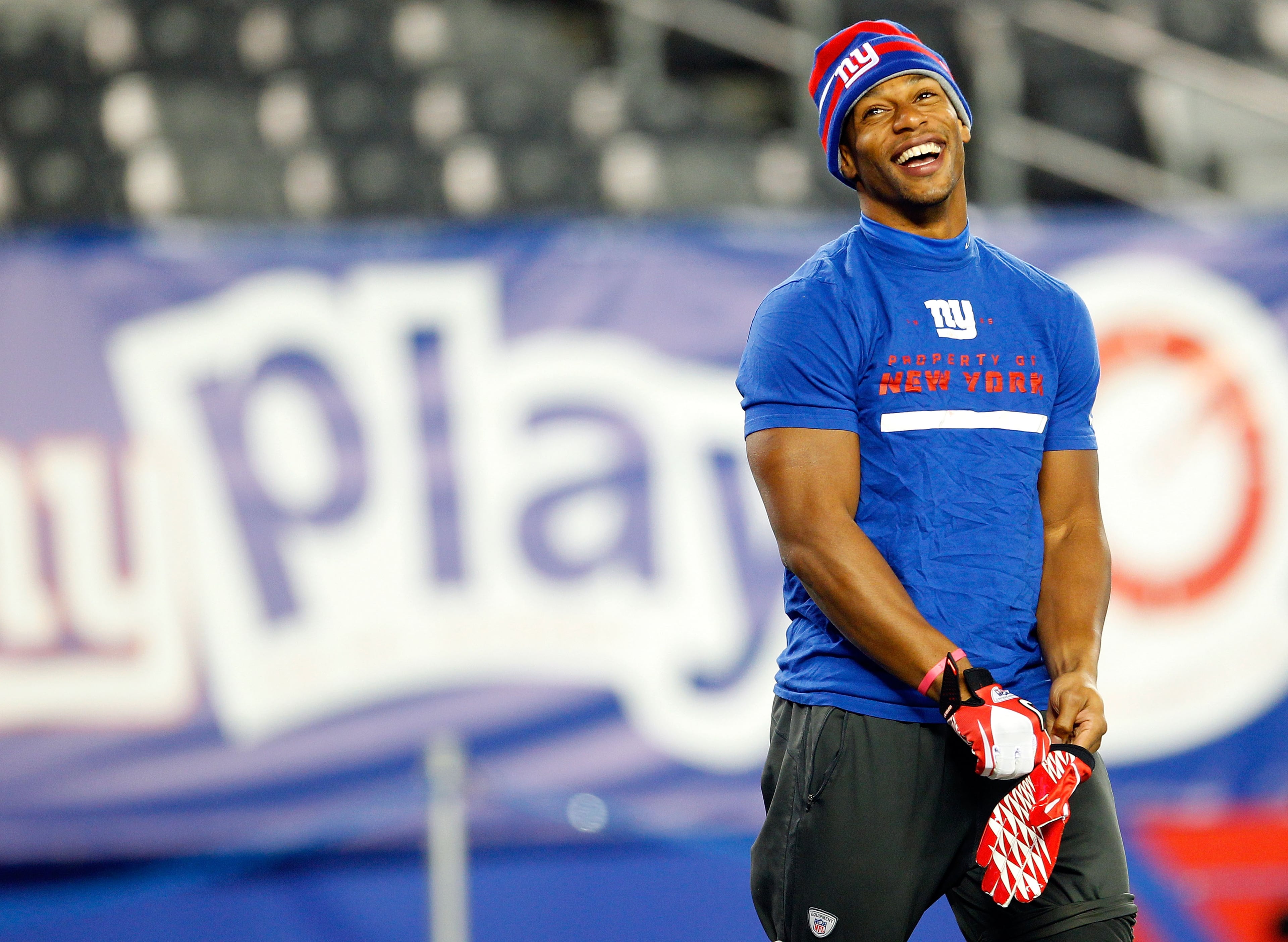 Wide receiver Victor Cruz of the New York Giants smiles while warming up prior to playing against the Green Bay Packers at MetLife Stadium on Nov. 25, 2012, in East Rutherford, N.J.