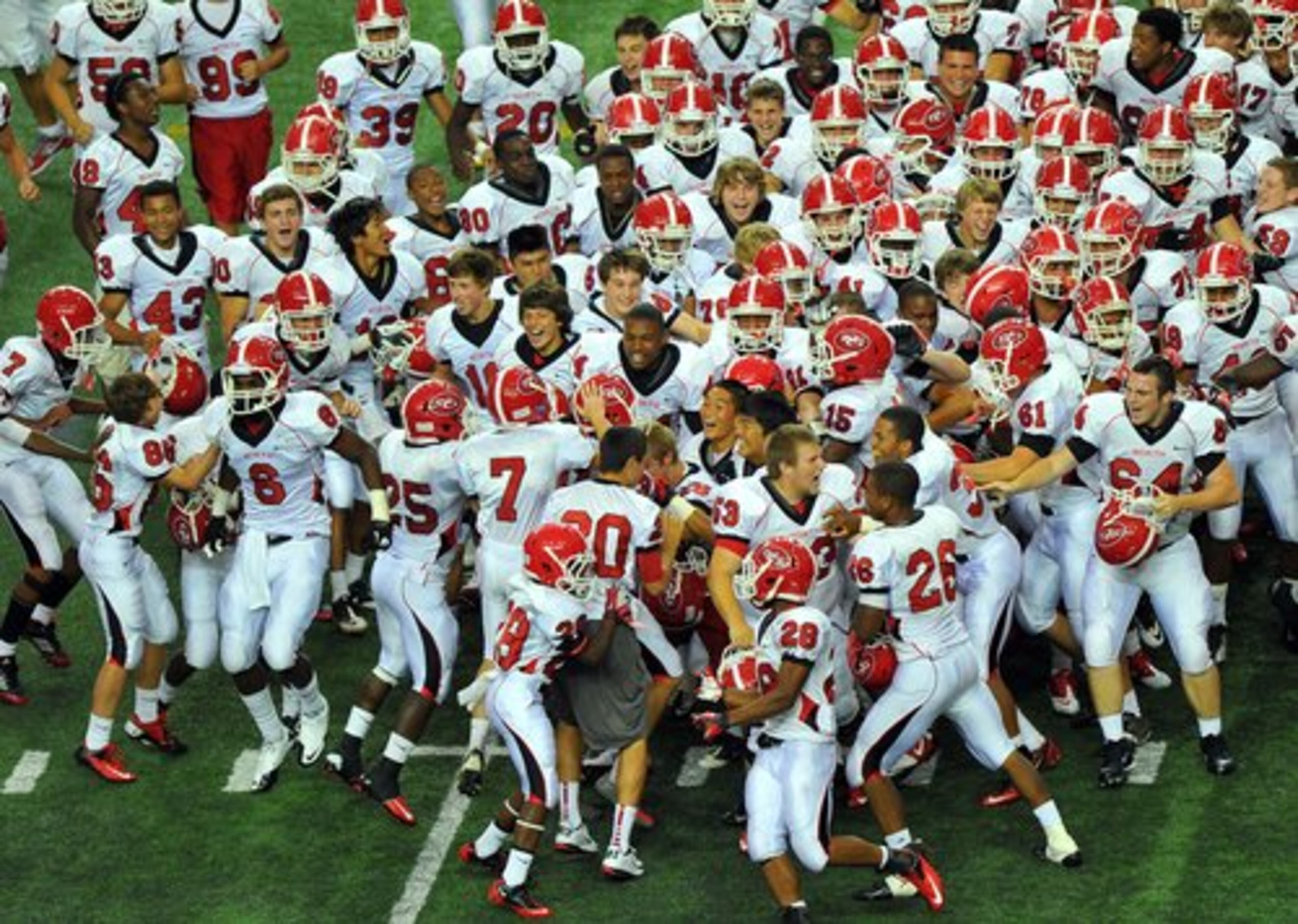 North Gwinnett players rush the field after Michael D' Angola kicked the game winning field goal as time expired.