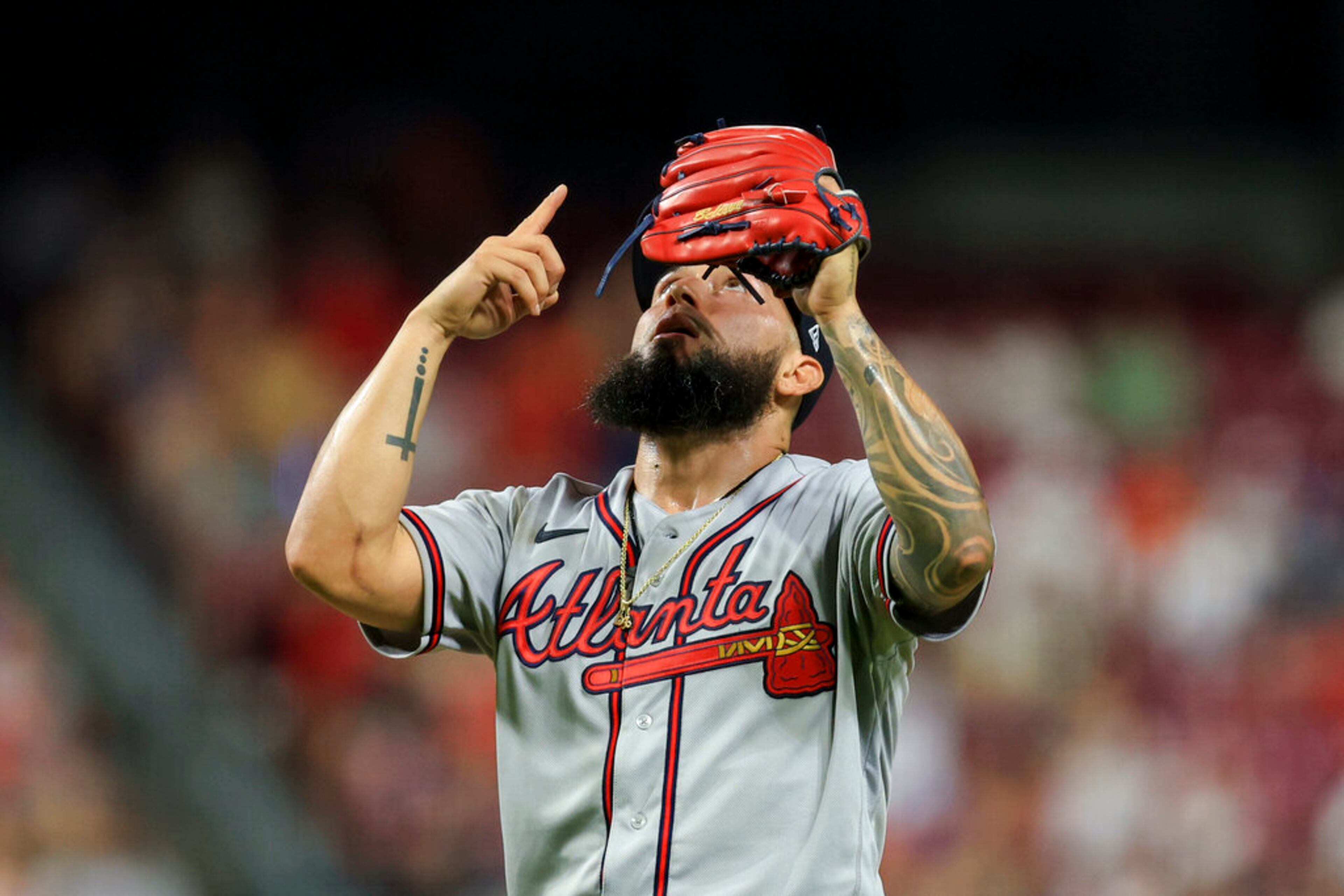 Atlanta Braves' Silvino Bracho points skyward after the final out of the team's baseball game against the Cincinnati Reds in Cincinnati, Friday, July 1, 2022. The Braves won 9-1. (AP Photo/Aaron Doster)