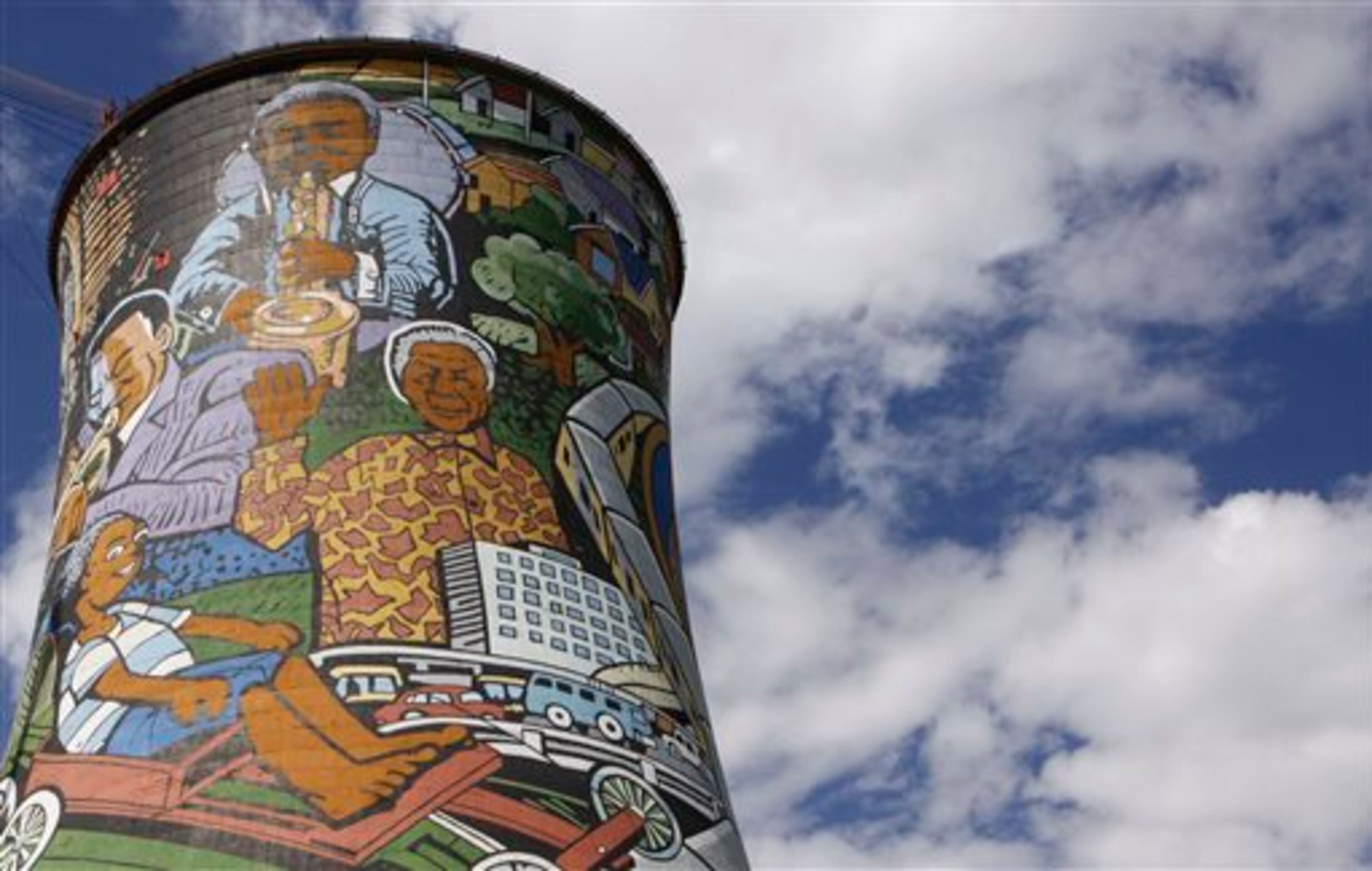 FILE - A portrait of former President Nelson Mandela adorns the center of a mural on a cooling tower of a defunct power station in Soweto, South Africa, in this Dec. 10, 2012 file photo. On Thursday, Dec. 5, 2013, Mandela died at the age of 95. (AP Photo/Denis Farrell, File)