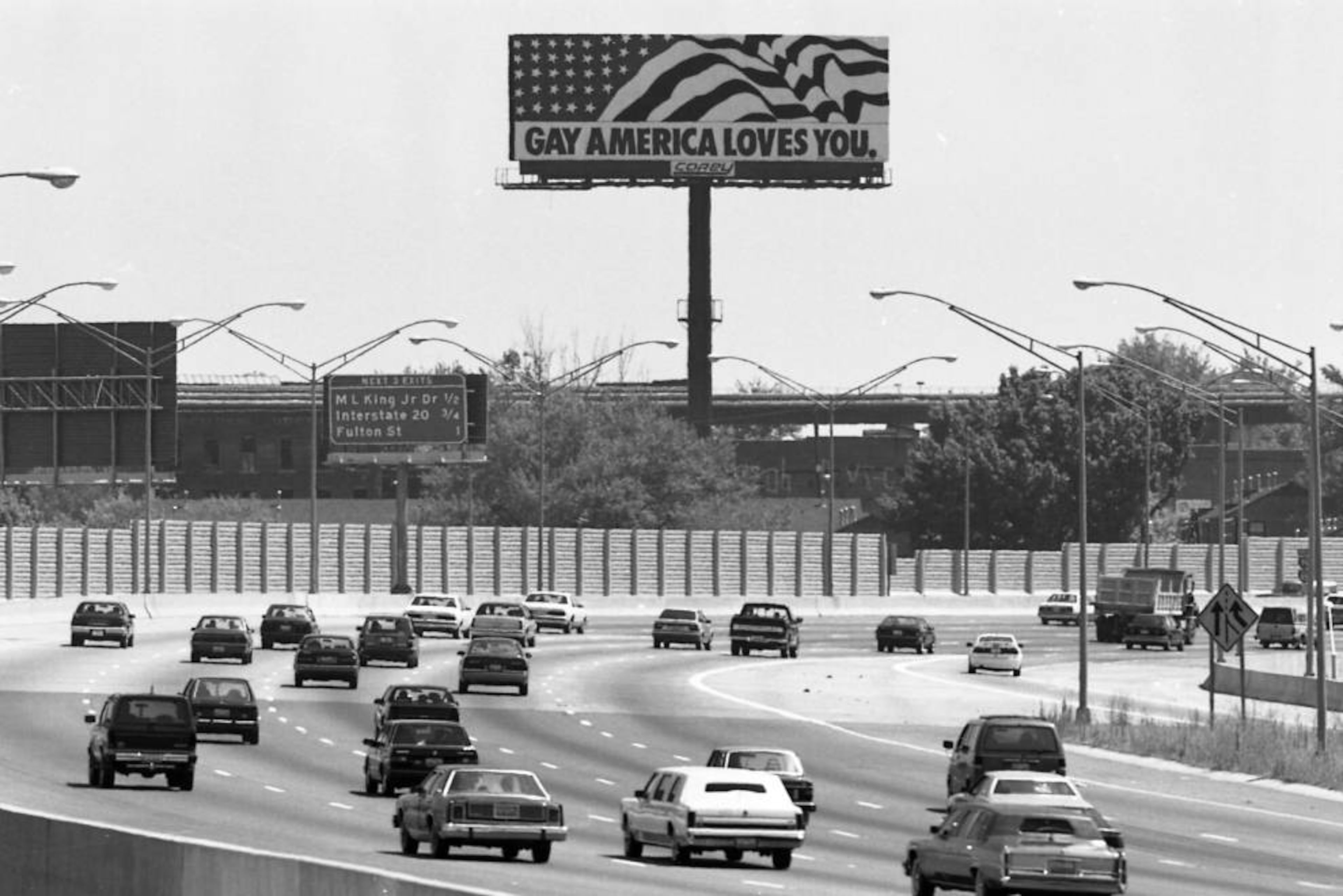 A billboard "Gay America Loves You," billboard, looking south down the Downtown Connector, Atlanta, Georgia, June 20, 1990. PHOTO BY WILLIAM BERRY / AJC ARCHIVES