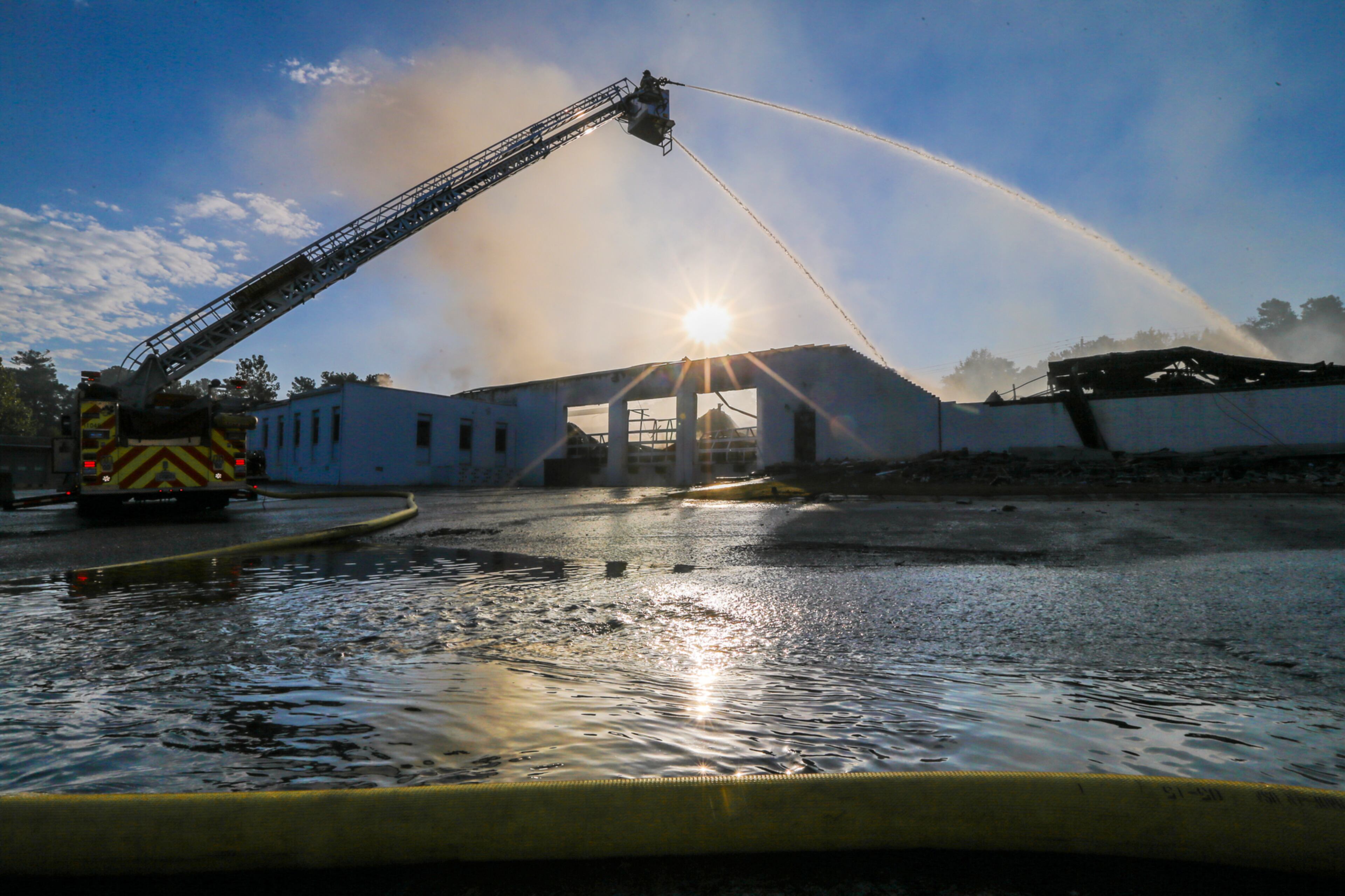 September 29, 2016 Atlanta: Raging flames destroyed much of a DeKalb County warehouse and caused the roof to collapse in the 2400 block of Lithonia Industrial Boulevard DeKalb County Fire Rescue Department officials said. Initial reports indicate no one was in the warehouse at the time of the fire, which started just before 6 a.m. and burned everything from paint to tires to vehicles. "The roof collapsed in stages," Jackson said. "First one far end collapsed, and then the middle and then the end." At one point, crews used three aerial ladders and at least 10 trucks to saturate the building with thousands of gallons of water. Investigators said while the burning chemicals aren't believed to be toxic to the surrounding area, they are worried for the safety of firefighters who will need to enter the building. Units were battling the blaze from "a defensive position," meaning crews were outside the building occupied by the National Equipment Development Company Inc. NEDCO, a manufacturing business that helps fold textiles and apparel, is less than 1,000 feet from one of the fire department's station. "Our firefighters, of course knowing the area, literally looked out the back door and saw this business on fire," Jackson said. JOHN SPINK /JSPINK@AJC.COM