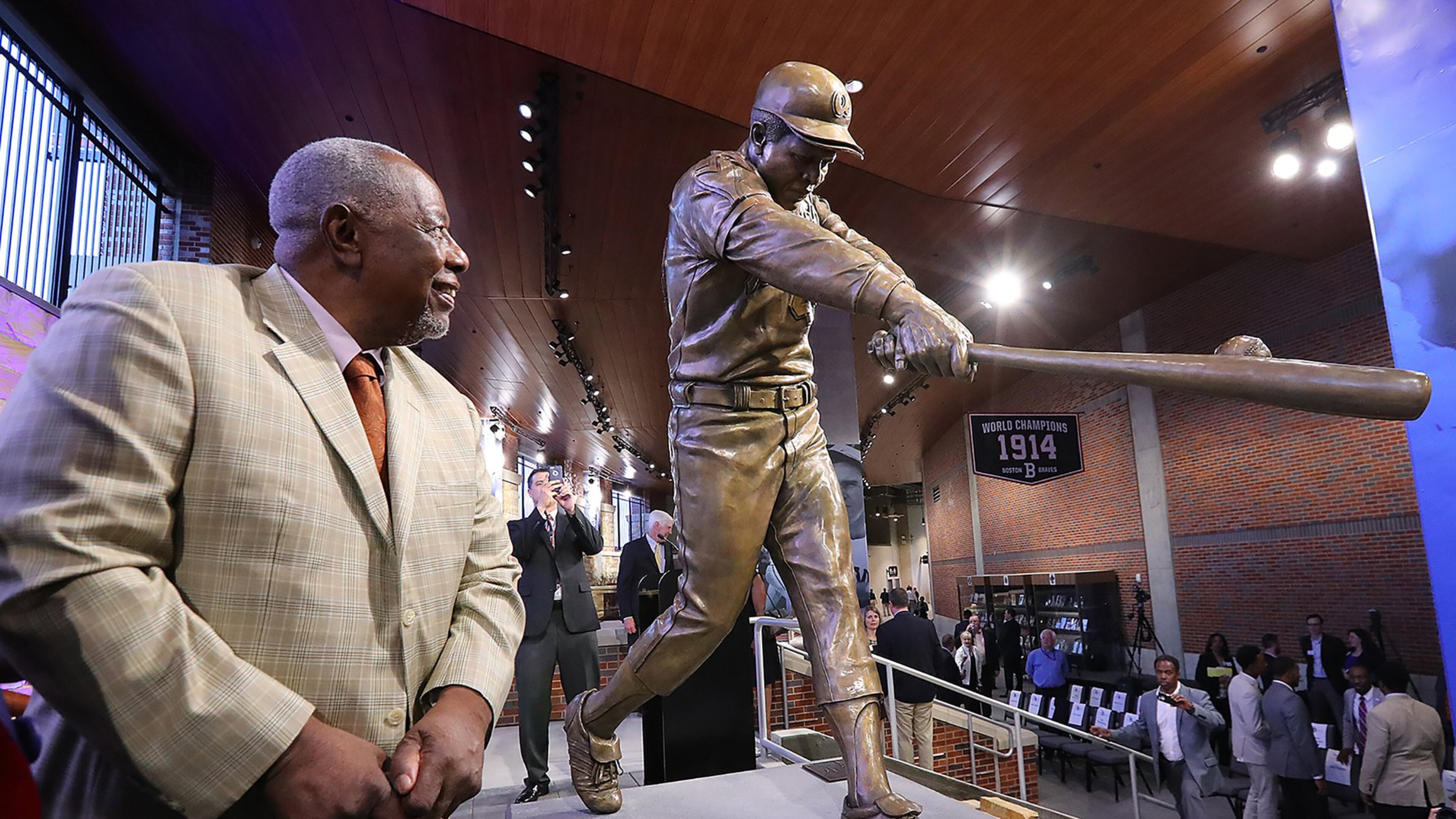 Hank Aaron views a new statue of him in Monument Grove at SunTrust Park. Baseball commissioner Rob Manfred, visiting Friday, said it might be the best baseball statue Manfred ever saw. (Curtis Compton/ccompton@ajc.com)