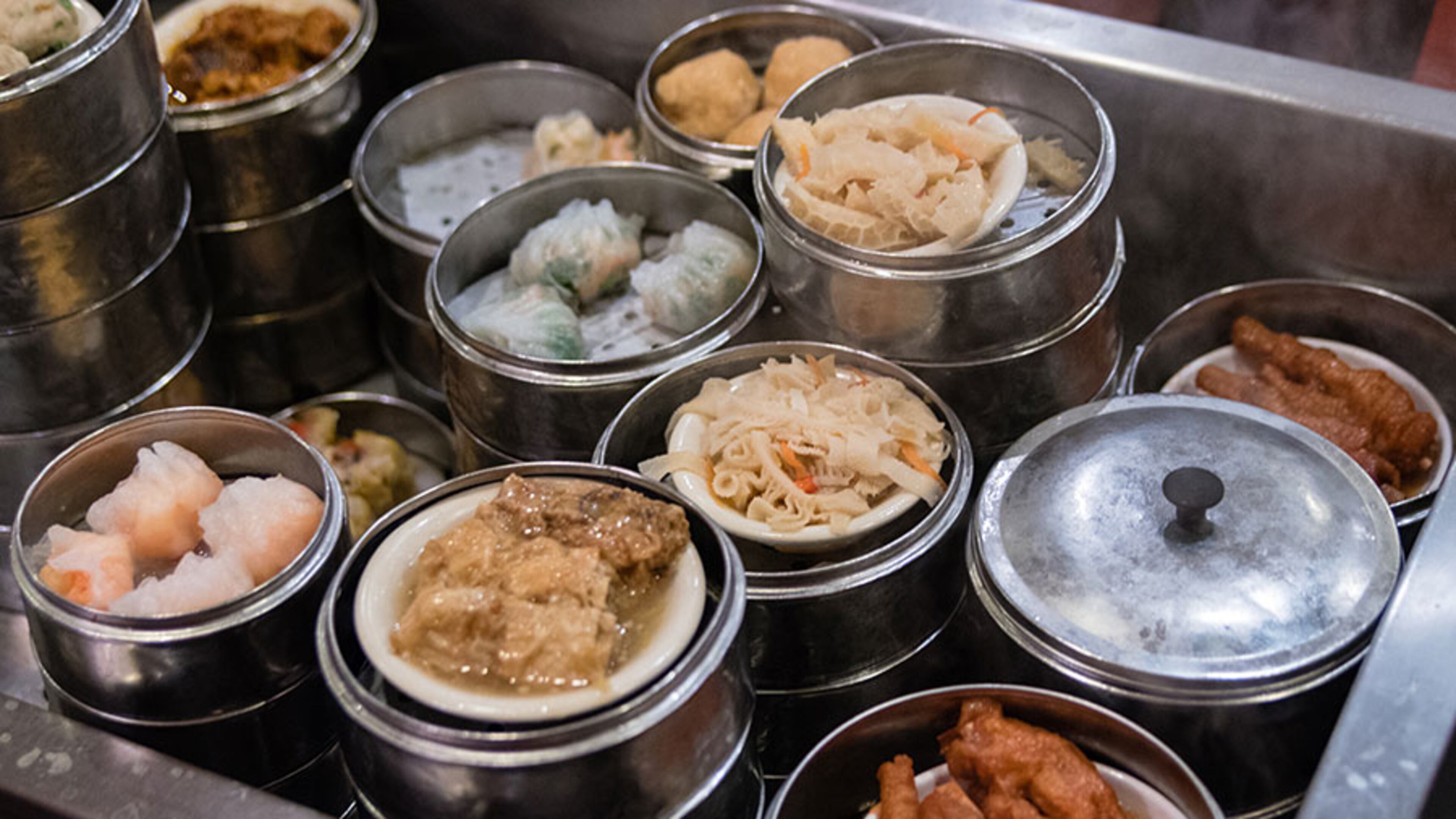 Dim sum carts billow steam as they're wheeled between the tables at Royal China in Chamblee. CONTRIBUTED BY HENRI HOLLIS