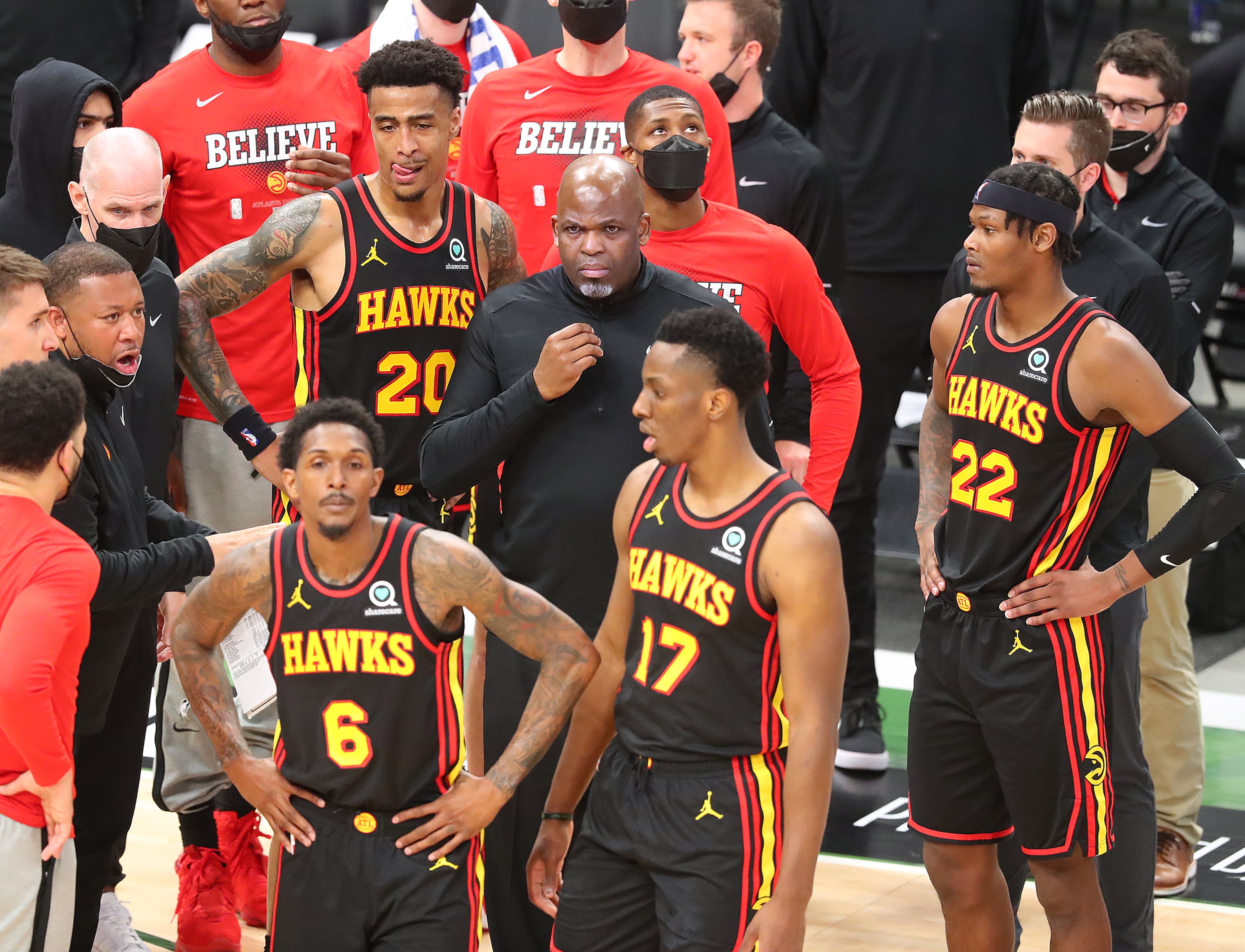 Hawks interim head coach Nate McMillan and his players look for answers during a timeout. “Curtis Compton / Curtis.Compton@ajc.com”