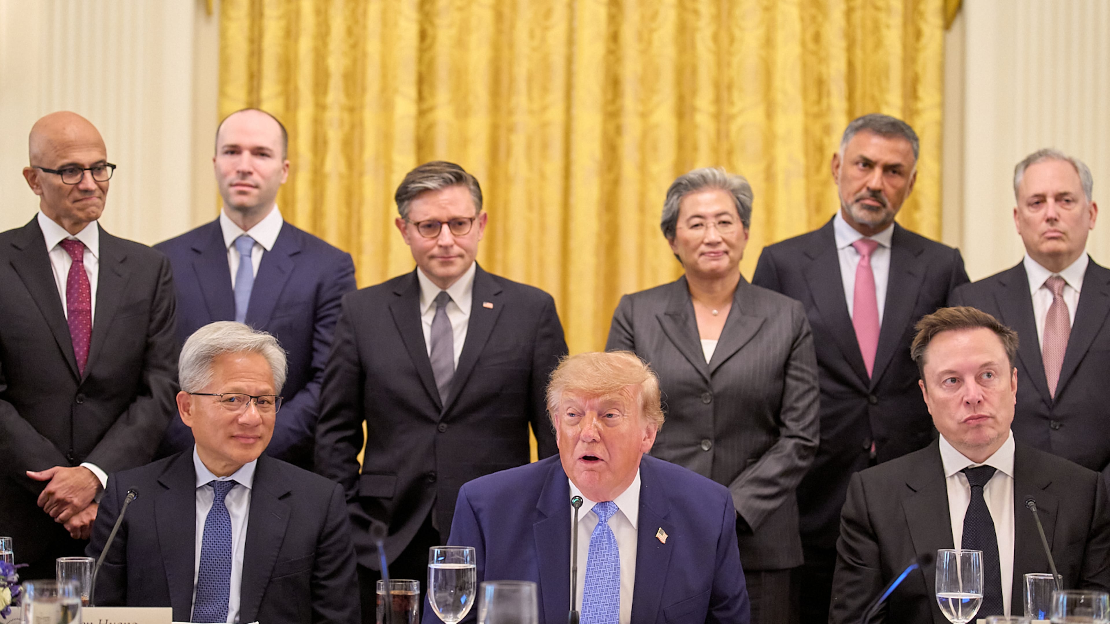 President Donald Trump, center, next to Nvidia CEO Jensen Huang, left, and Elon Musk, right, speaks in the East Room of the White House in Washington, Tuesday Sept. 29, 2026, surrounded by top executives of AI firms including, from top left, Microsoft CEO Satya Nadella, Greg Brockman, President of OpenAI, House Speaker Mike Johnson, AMD CEO Lisa Su, Palo Alto Networks Chief Executive Nikesh Arora, and David Sacks. (AP Photo/Jacquelyn Martin)