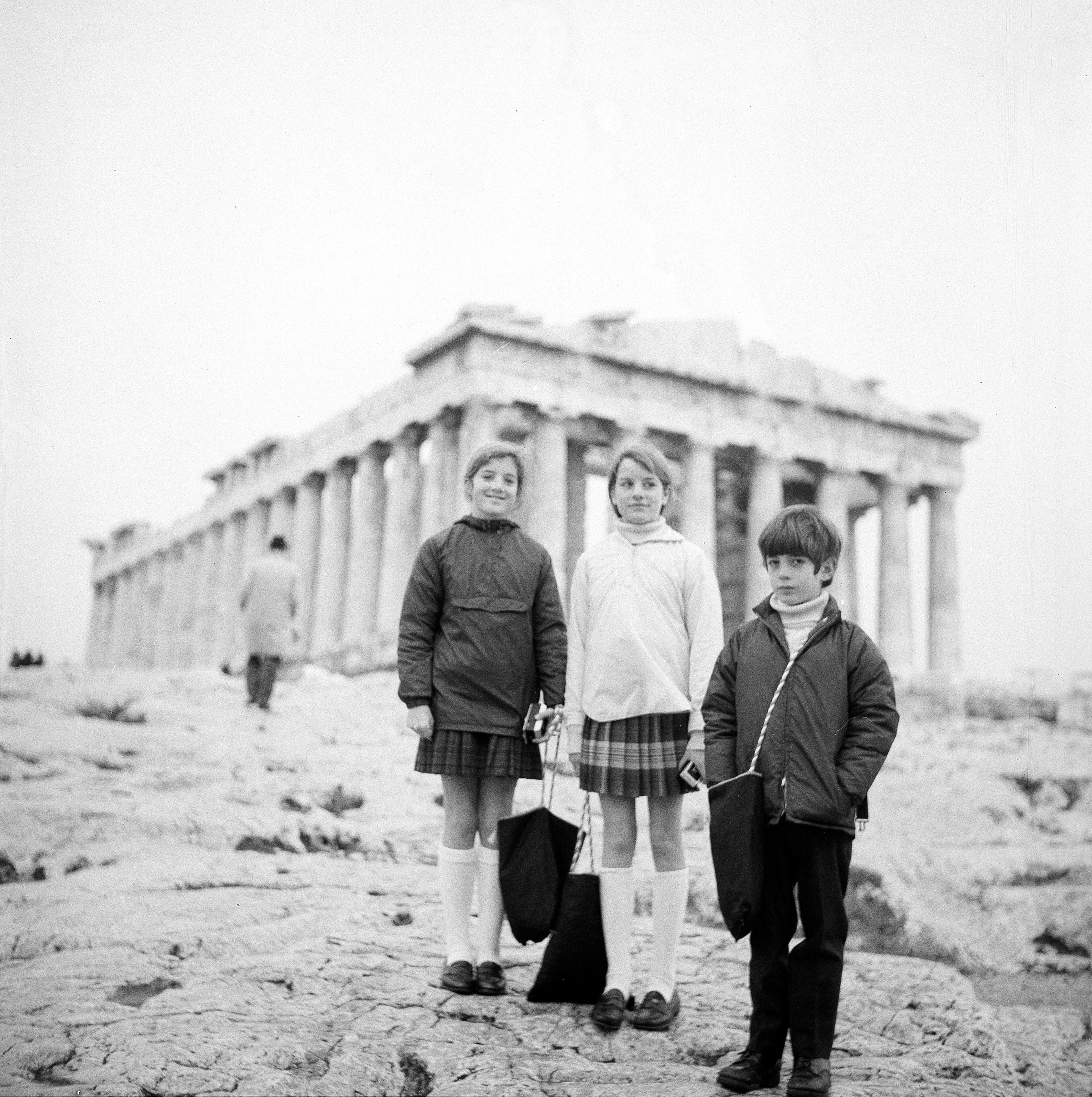 Caroline, left, and John Kennedy, Jr., children of the late U.S. president, flank an unidentified friend as they stand on the Acropolis in Athens, Greece, Jan. 3, 1969, where they are spending their holiday season. (AP Photo)