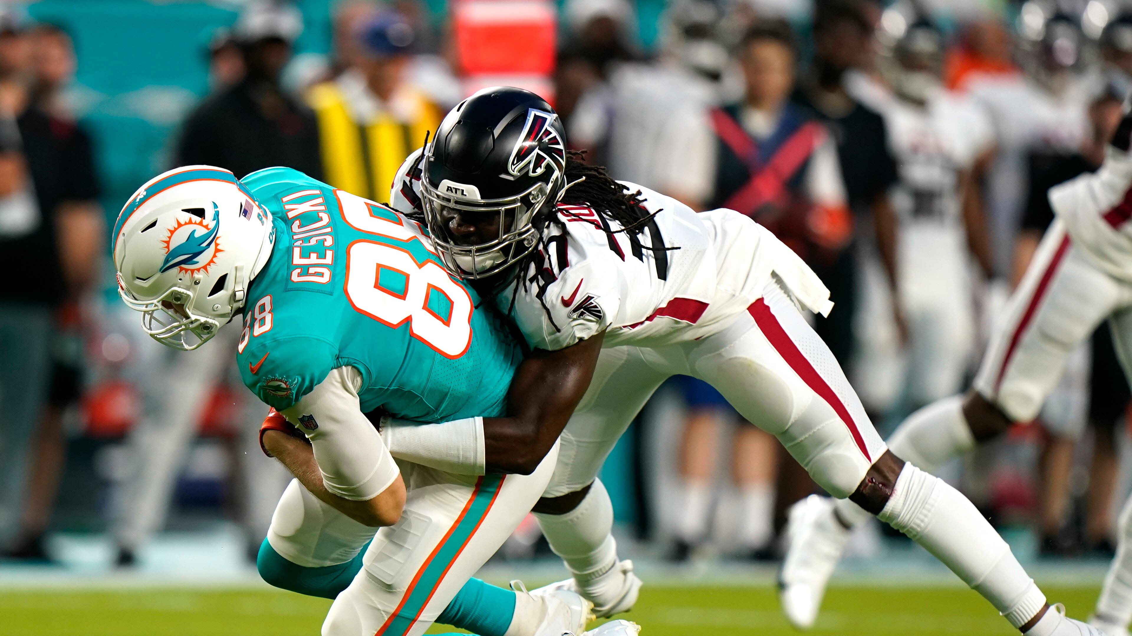 Atlanta Falcons safety Dwayne Johnson Jr. (37) tackles Miami Dolphins tight end Mike Gesicki (88) during the first half of a NFL preseason football game, Saturday, Aug. 21, 2021, in Miami Gardens. (AP Photo/Wilfredo Lee)