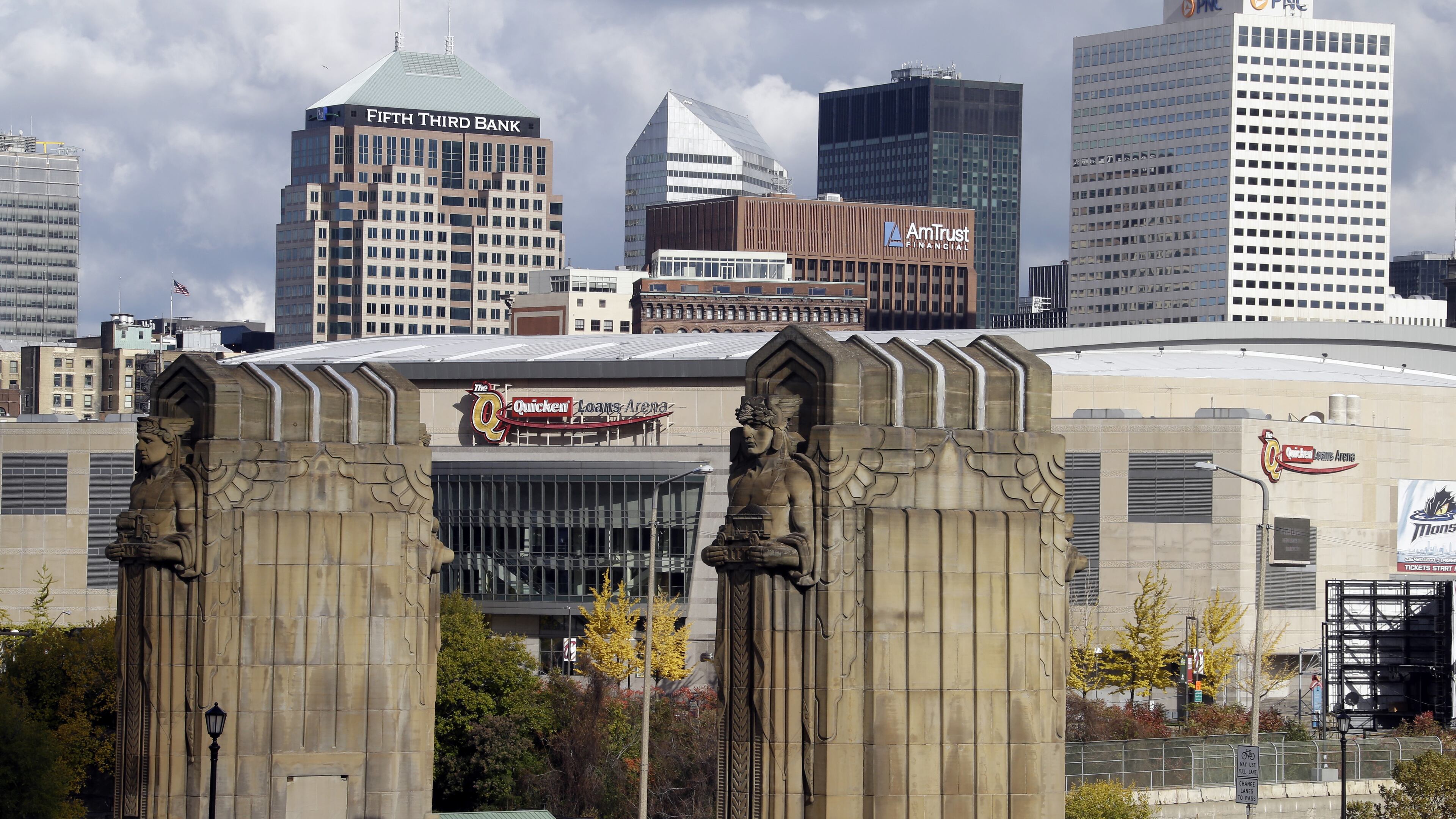 FILE - This Nov. 8, 2013, file photo shows Cleveland's skyline and the venue of the 2016 Republican National Convention, Quicken Loans Arena, framed by the Guardians of Traffic sculptures at the east end of the Hope Memorial Bridge in Cleveland. Donald Trump's effort to unite a splintered Republican Party around his candidacy is about to take center stage in a city that is itself deeply fractured. (AP Photo/Mark Duncan, File)