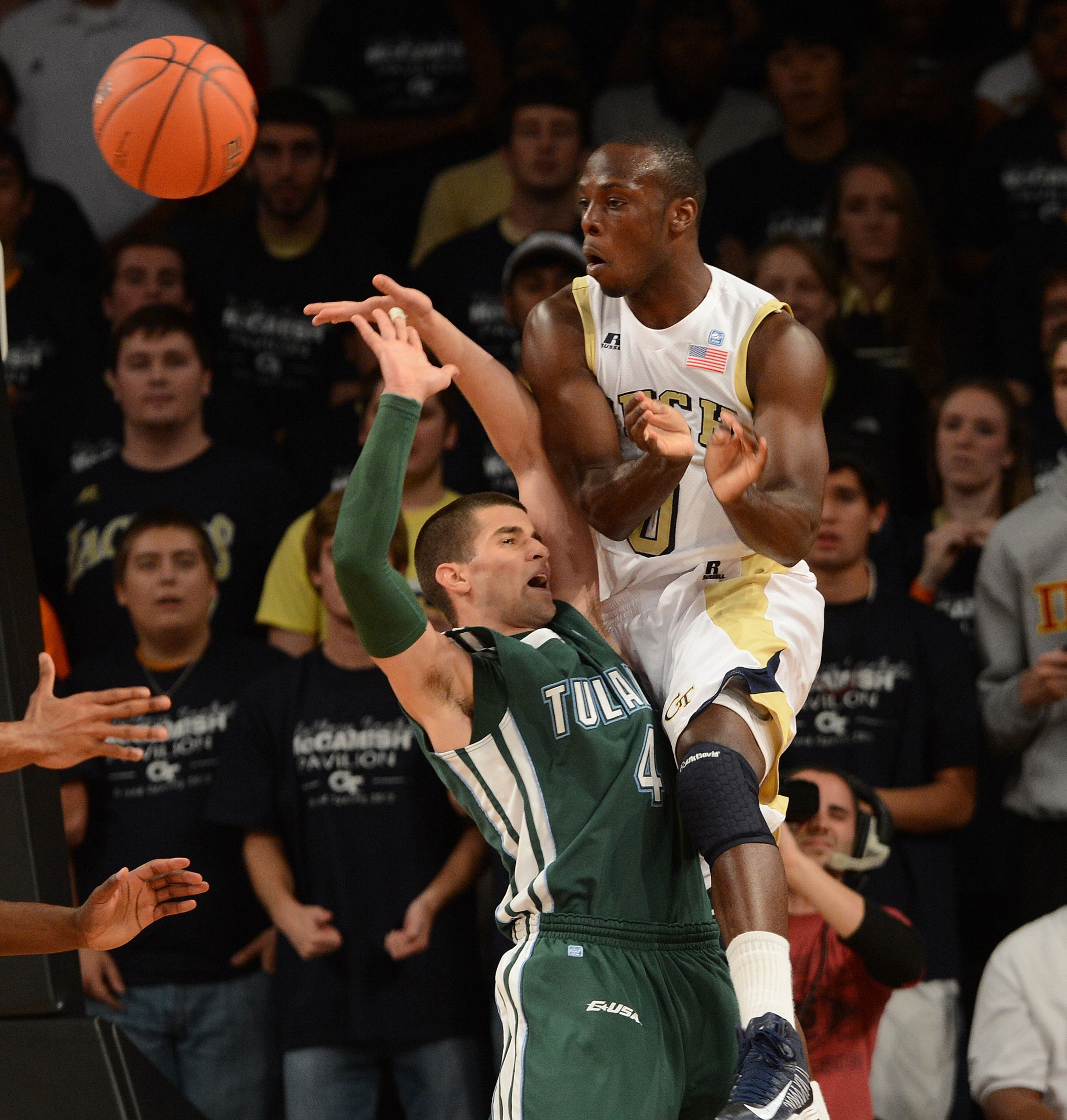 Mfon Udofia of Georgia Tech passes the ball inside against Tulane's Ben Cherry (4).