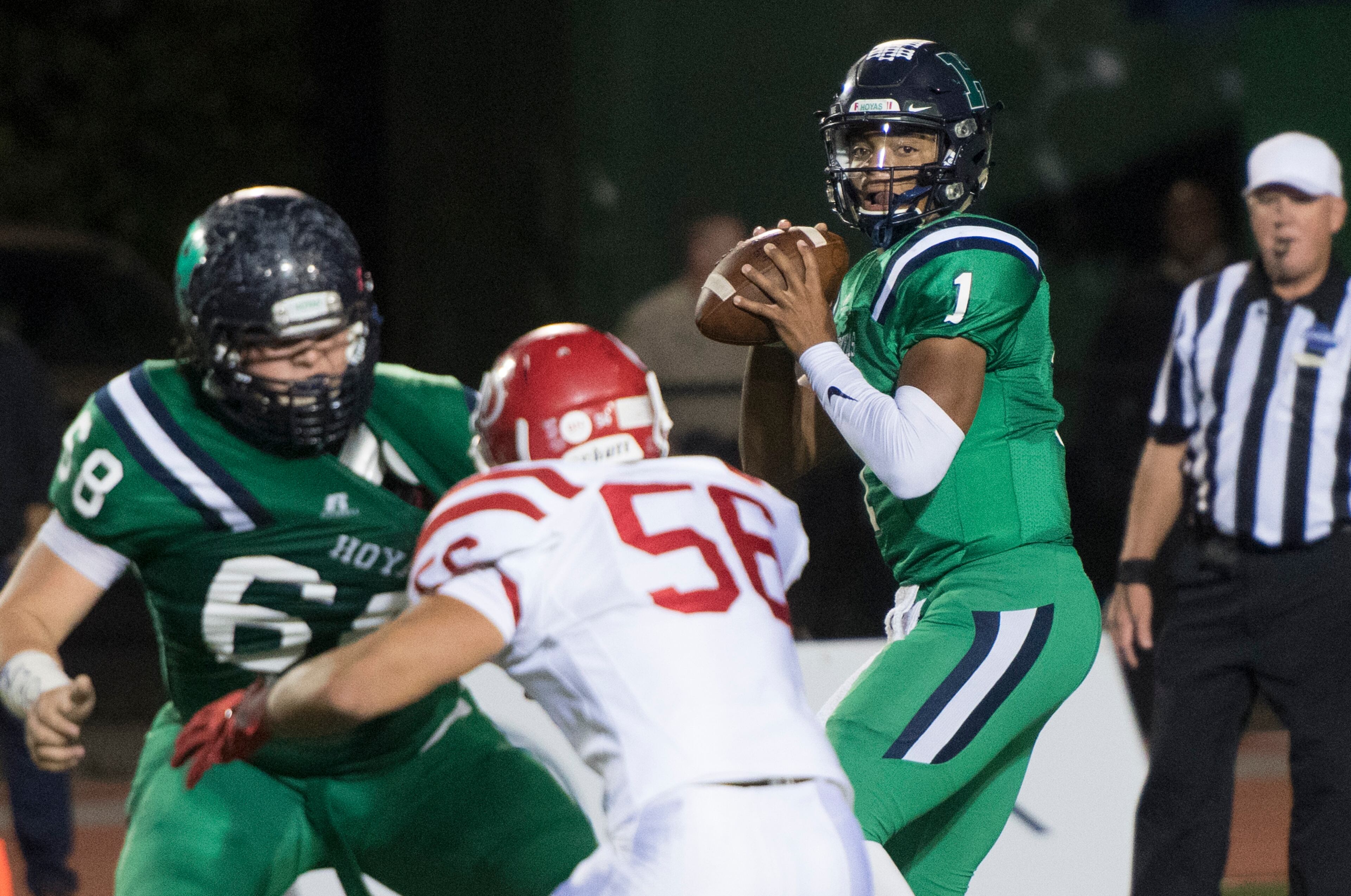 Harrison quarterback Justin Fields (1) looks to pass as lineman Andrew Waller (68) provides protection against Dalton defensive end Kevin Diaz (56) during a high school football game on Thursday, Oct. 19, 2017, in Kennesaw, Ga. (Special to the Atlanta Journal-Constitution, John Amis )