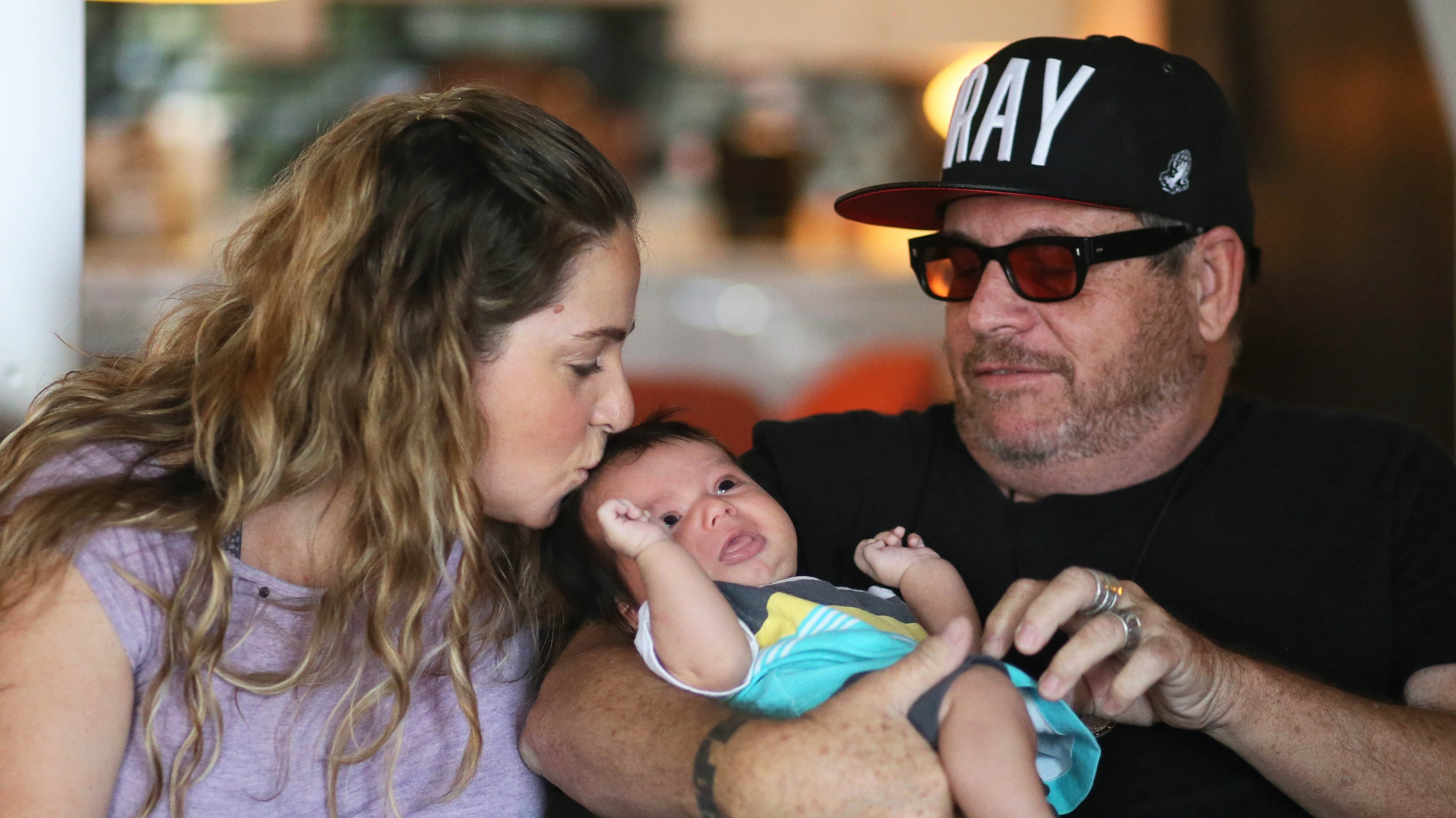 Grant Henry (right) with his daughter, Mary Grace Henry and 6 week old grandson Emilio Fromow Henry at his apartment. Grant Henry, a former seminary student and church deacon--owns Church, named best themed bar in the world by BuzzFeed. It's also been the hangout of celebrities including Lady Gaga, Ben Stiller and Owen Wilson. He plans to open a new Church in Athens in mid-September. BOB ANDRES / BANDRES@AJC.COM