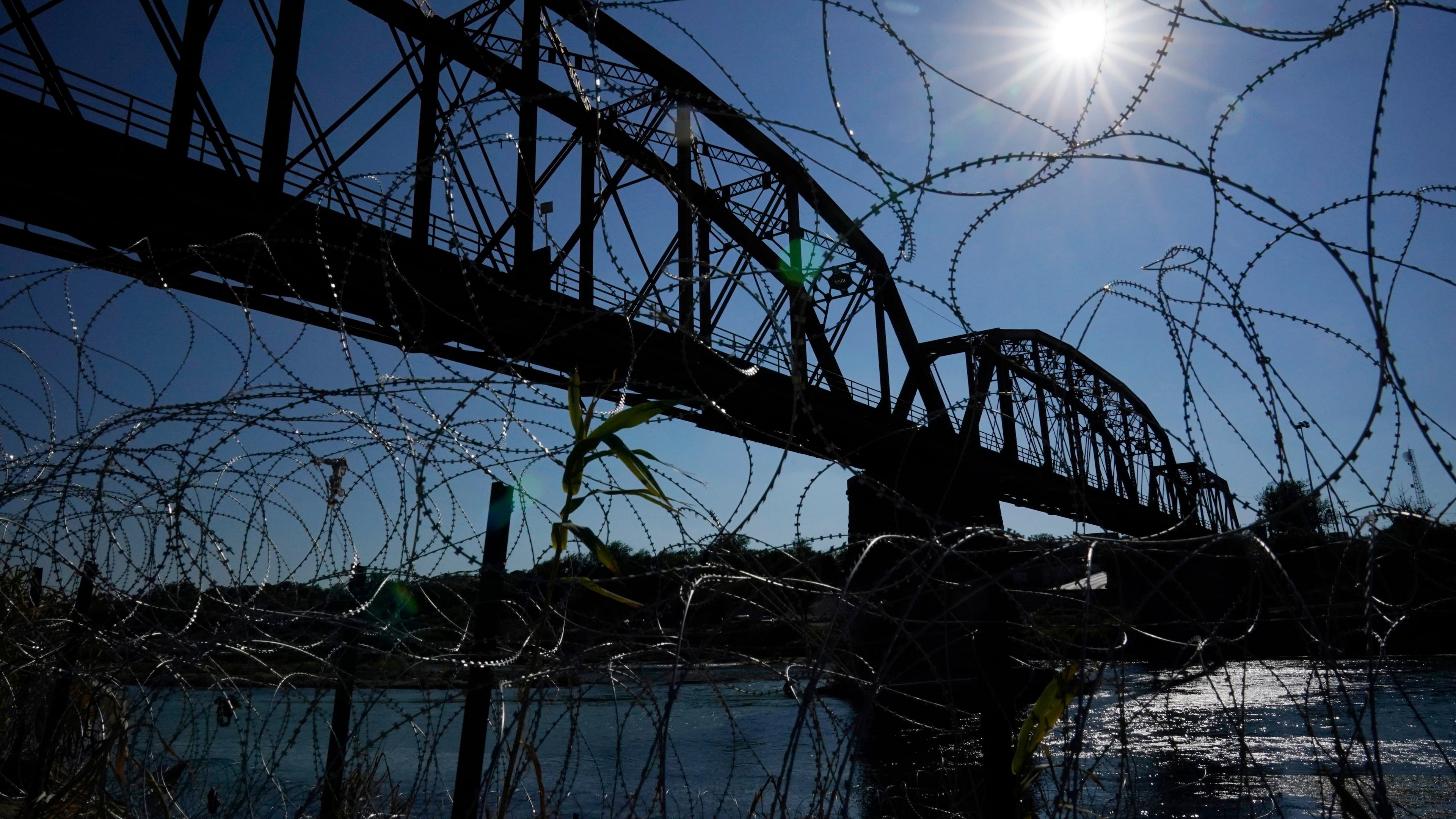 FILE - The Union Pacific International Railroad Bridge is seen behind concertina wire, Sept. 22, 2023, in Eagle Pass, Texas. (AP Photo/Eric Gay, File)