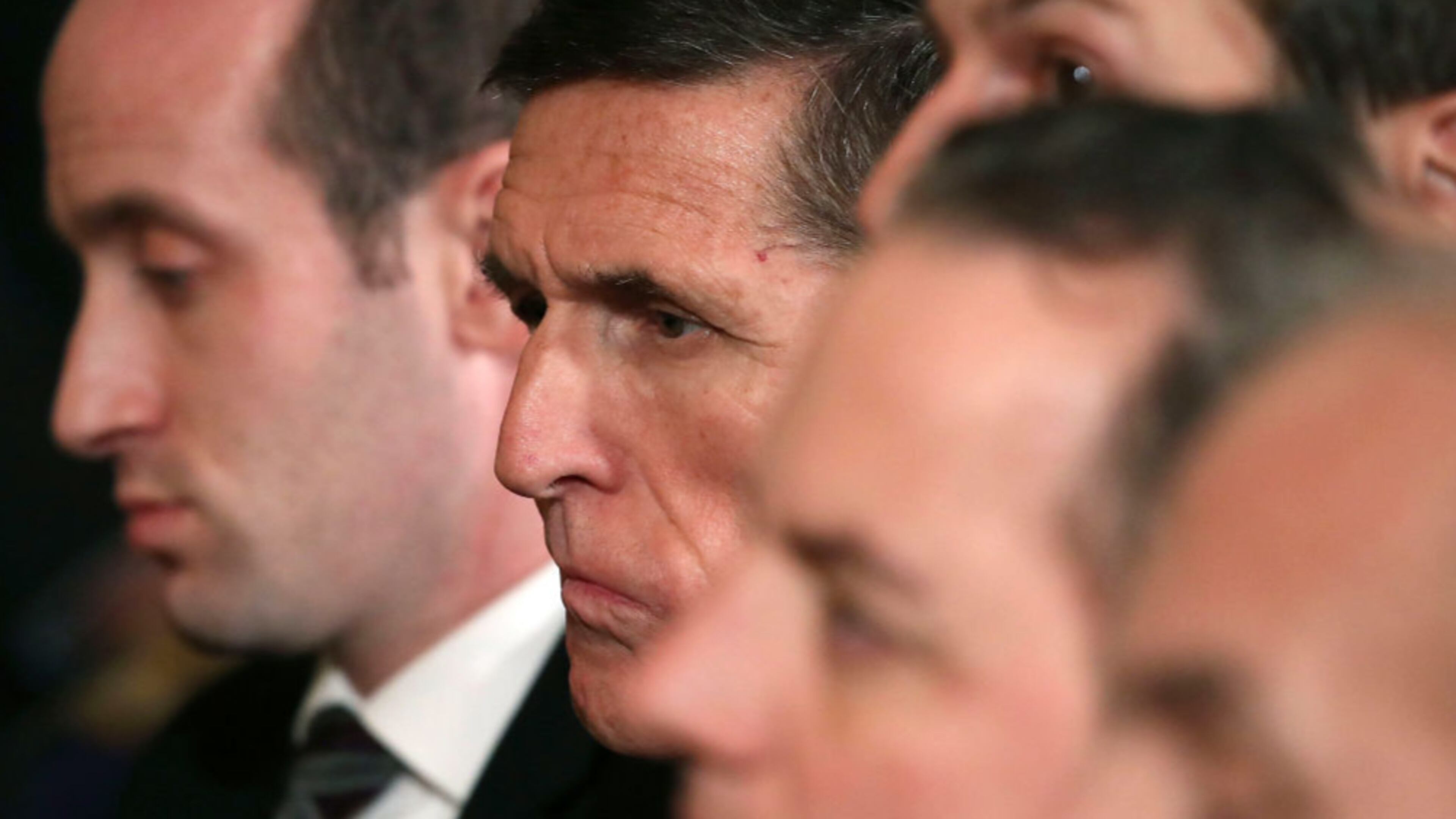 Former National Security Adviser Michael Flynn (2ndL) attends a joint news conference with U.S. President Donald Trump and Canadian Prime Minister Justin Trudeau in the East Room of the White House February 13, 2017 in Washington, DC.