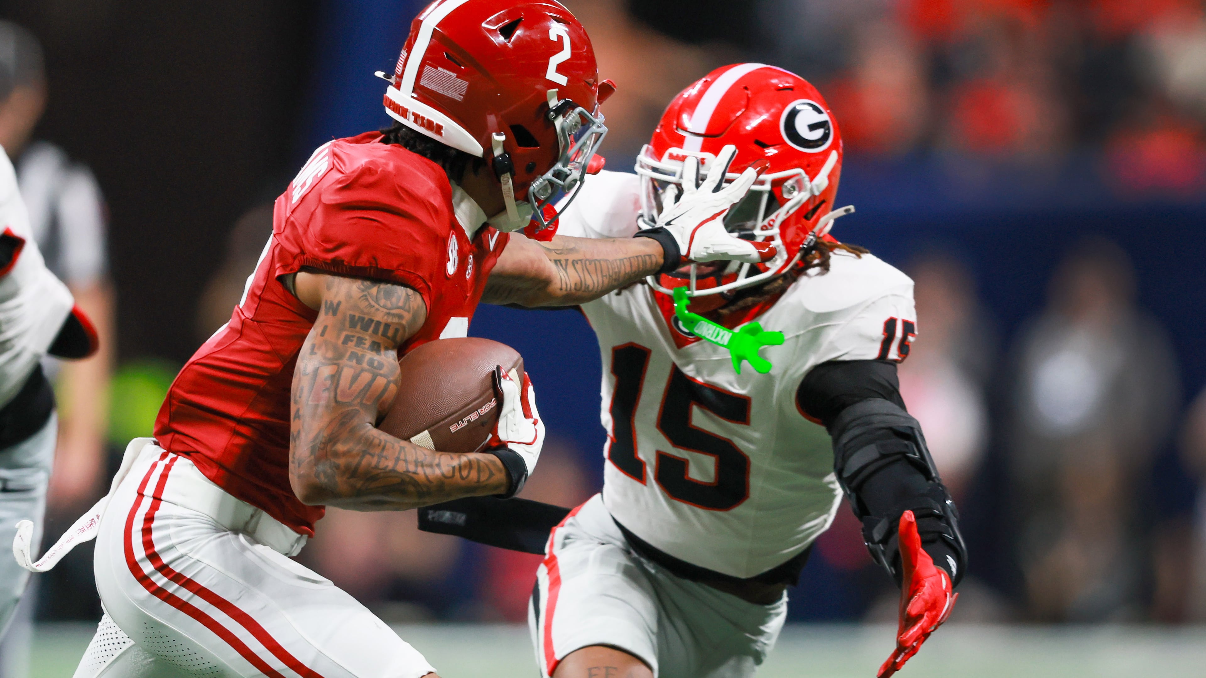 Alabama wide receiver Ryan Williams pushes Georgia defensive back Demello Jones away with a hand to the face during the first half of the SEC Championship game at Mercedes-Benz Stadium, Saturday, Dec. 6, 2025, in Atlanta. (Jason Getz/AJC)
