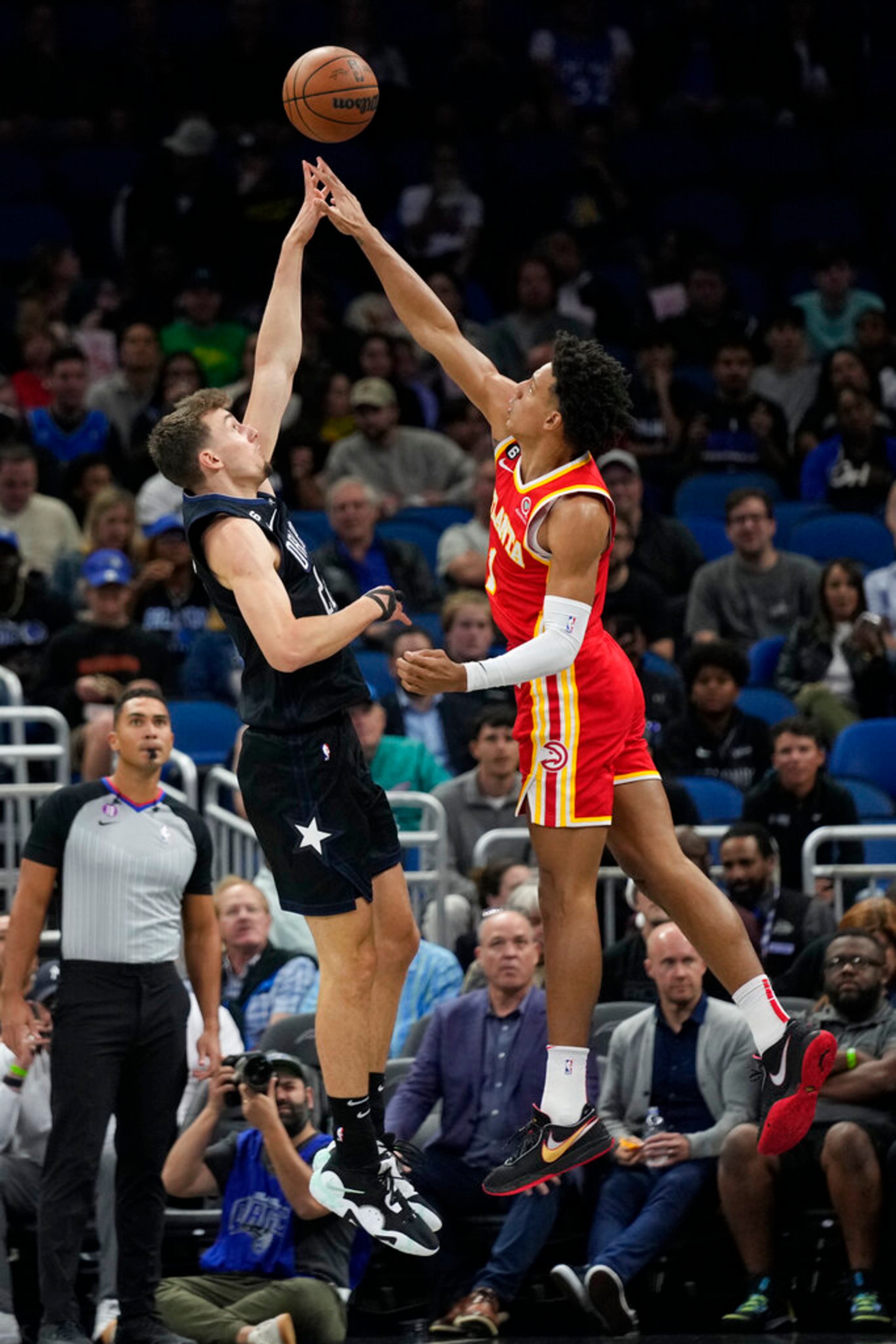 Orlando Magic's Franz Wagner, left, attempts a shot over Atlanta Hawks' Jalen Johnsonduring the first half of an NBA basketball game, Wednesday, Dec. 14, 2022, in Orlando, Fla. (AP Photo/John Raoux)