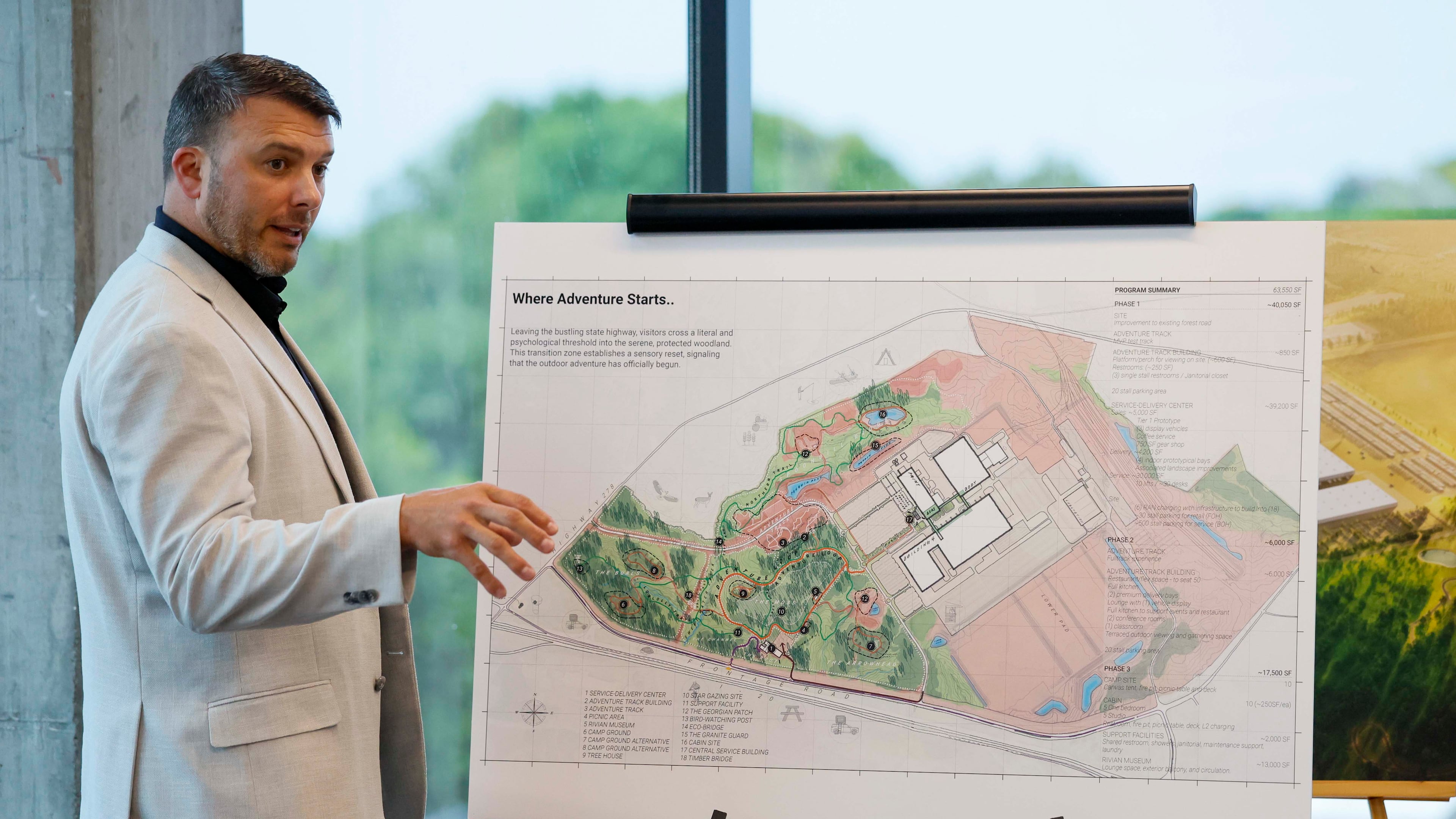 Jimmy Knauf, executive vice president of facilities at Rivian, describes the design of the Stanton Springs plant, based on a rendering, after touring Rivian’s East Coast headquarters in Atlanta on Tuesday, Aug. 4, 2026. (Miguel Martinez/AJC)