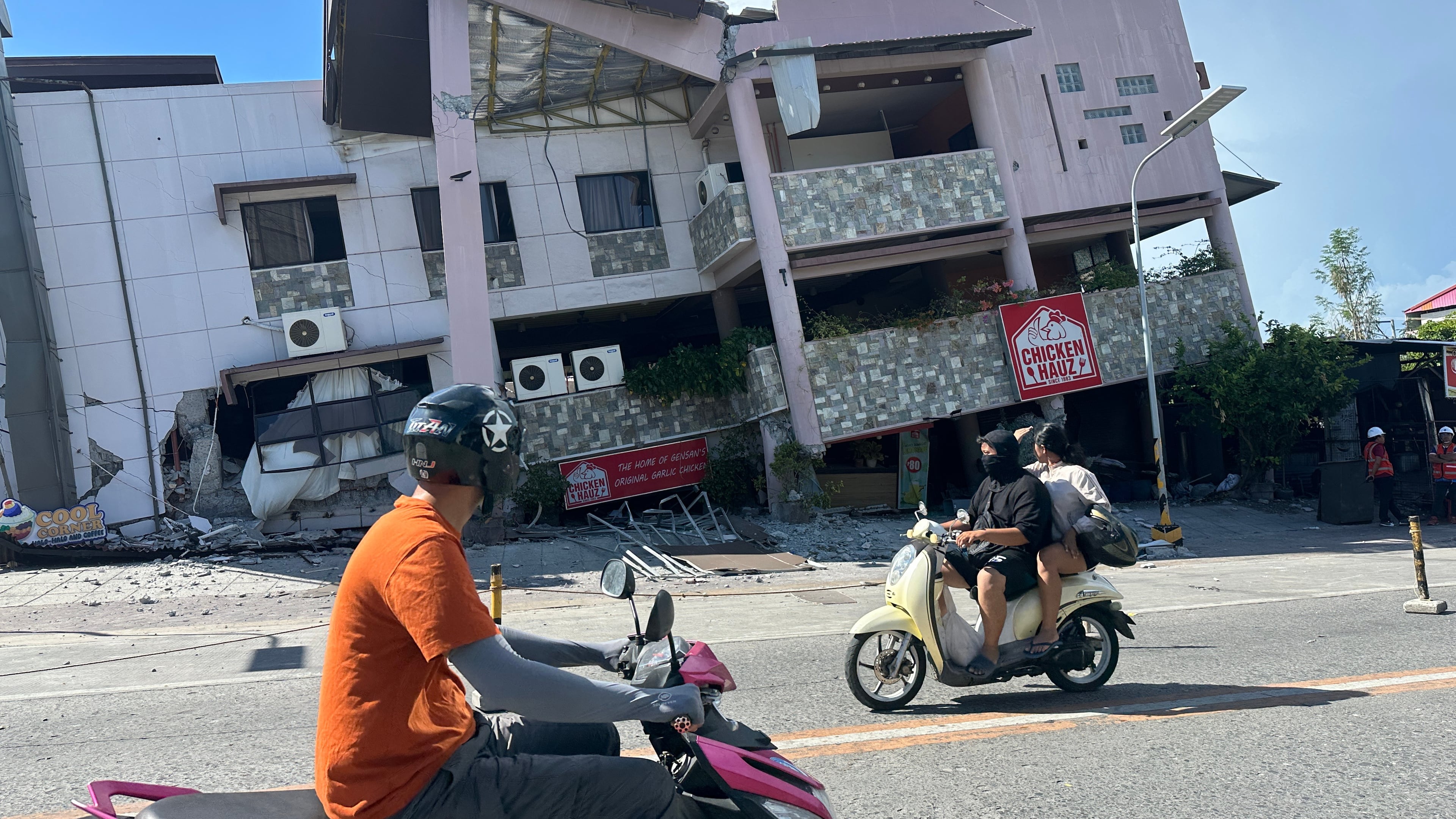 Residents pass by a collapsed structure after an earthquake in General Santos, Philippines on Monday, June 8, 2026. (AP Photo)