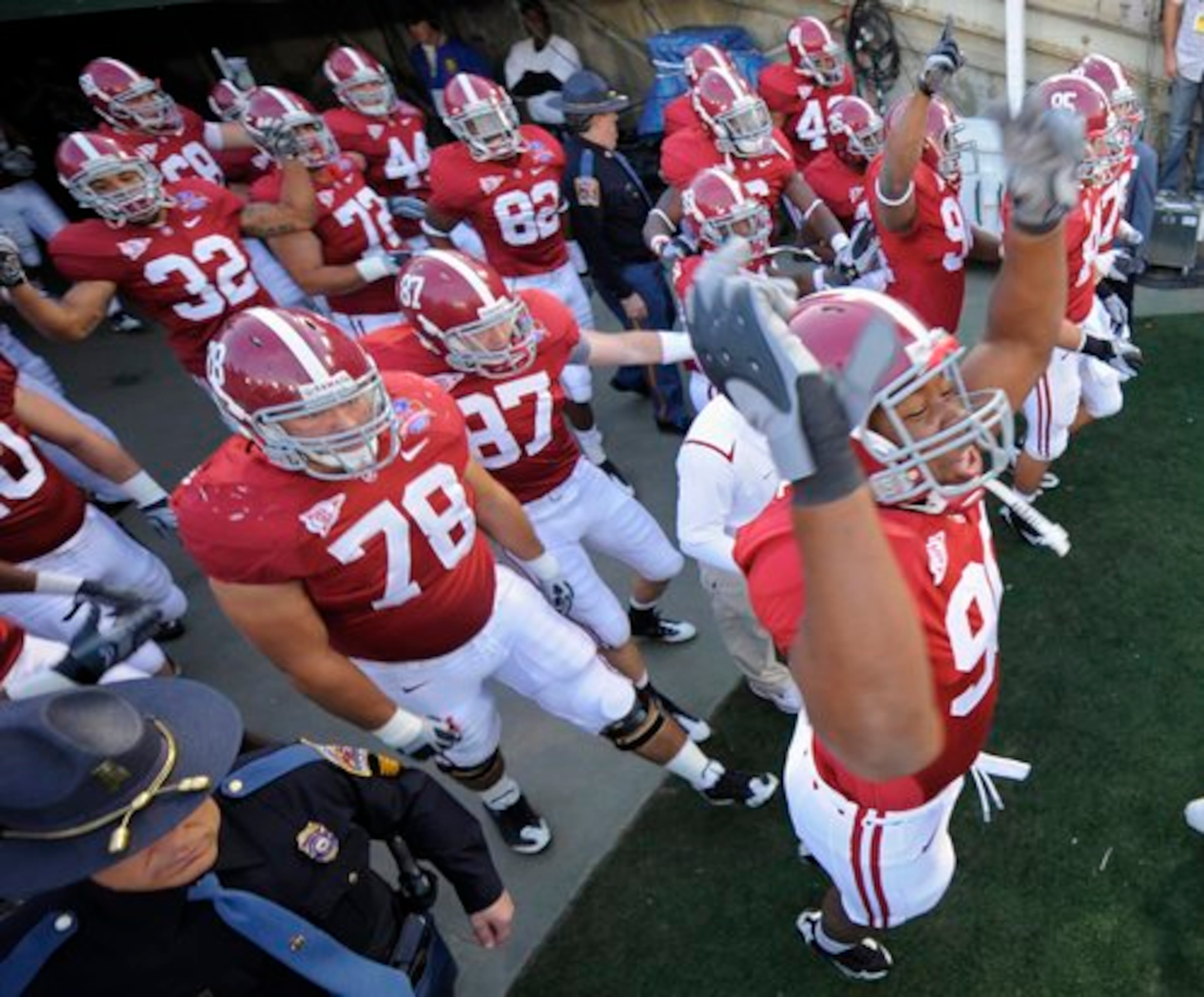 Alabama defensive lineman Milton Talbert, right, reacts as the Crimson Tide takes the field.