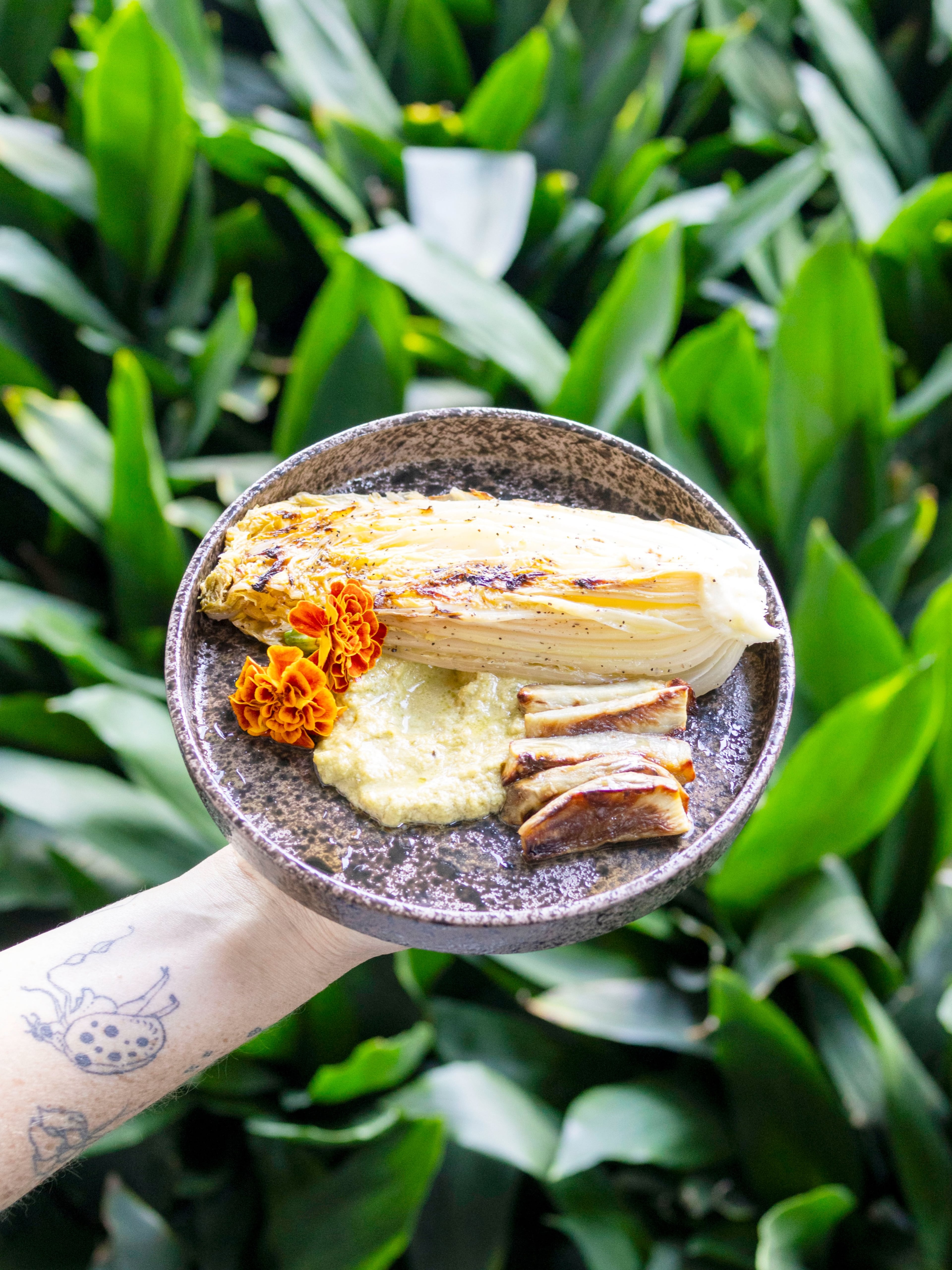 Kyle Taylor’s slow-roasted savoy cabbage, compressed kohlrabi, mustard leaf oil, emerald brassica emulsion and mustard blossoms. (Courtesy of Cary Smith)
