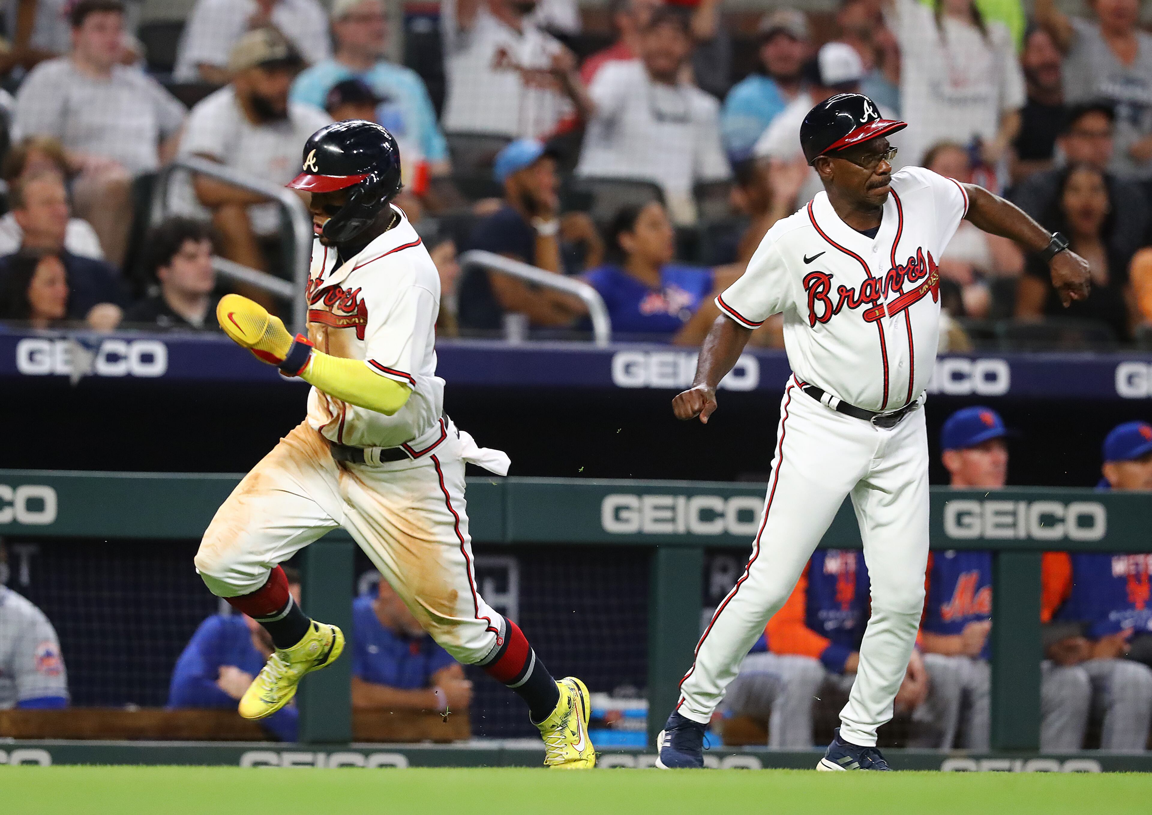 Braves third base coach Ron Washington waves Ronald Acuna home to score all the way from first base on a RBI-single by Dansby Swanson for a 4-0 lead over the New York Mets during the seventh inning in a MLB baseball game on Tuesday, August 16, 2022, in Atlanta. “Curtis Compton / Curtis Compton@ajc.com