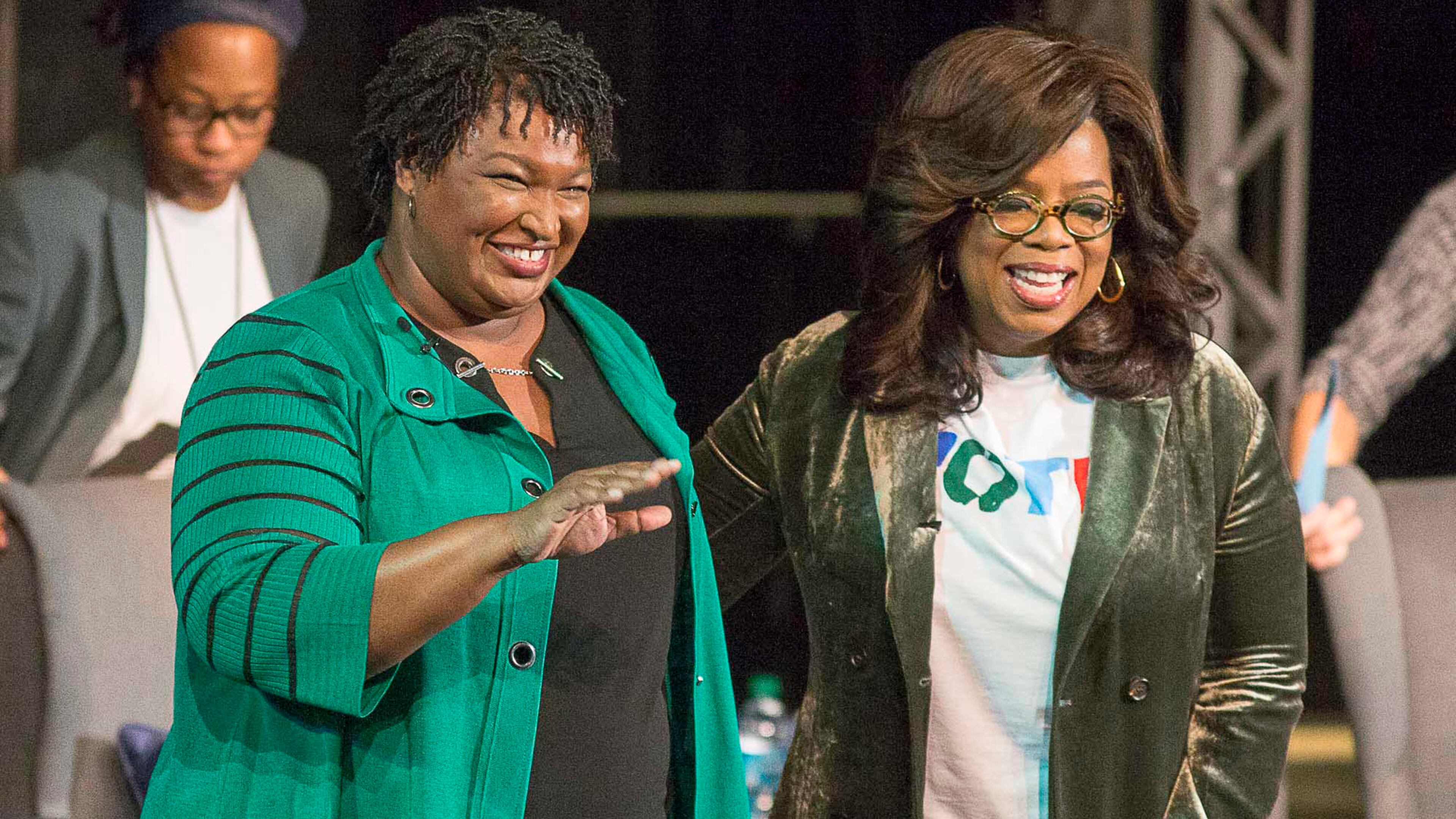 Oprah Winfrey and Stacey Abrams greet a crowd gathered for a town hall conversation at the Cobb Civic Center on Nov. 1, 2018.