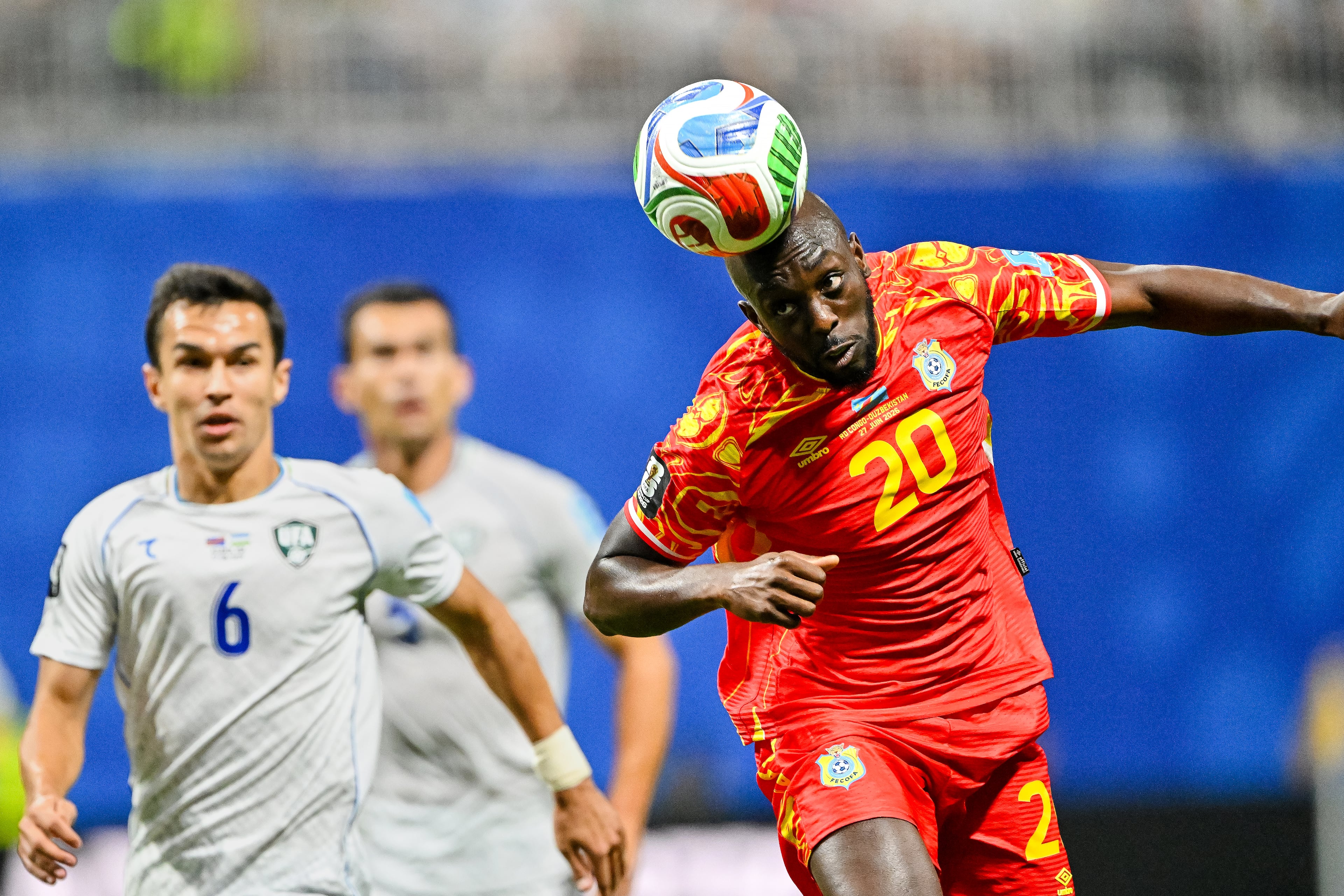 Congo forward Nathanaël Mbuku (right) heads the ball upfield against Uzbekistan midfielder Akmal Mozgovoy (left) during the first half of a FIFA World Cup match at Atlanta Stadium (Mercedes-Benz Stadium) on Saturday, June 27, 2026, in Atlanta. (Hyosub Shin/AJC)