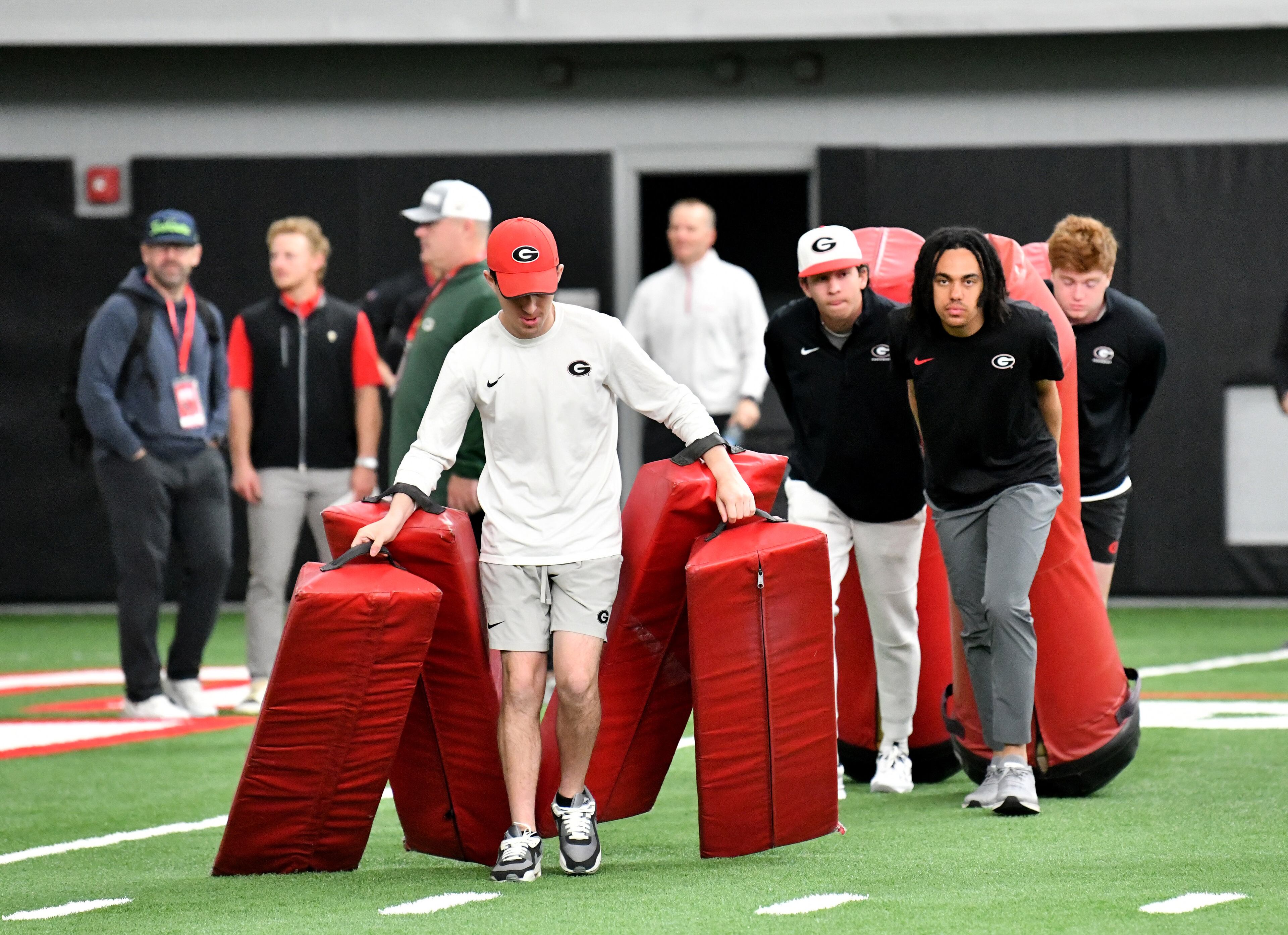 Staff members prepare for the next drills during Georgia Pro Day at Payne Indoor Athletic Facility, Wednesday, Mar. 13, 2024, in Athens. (Hyosub Shin / Hyosub.Shin@ajc.com)