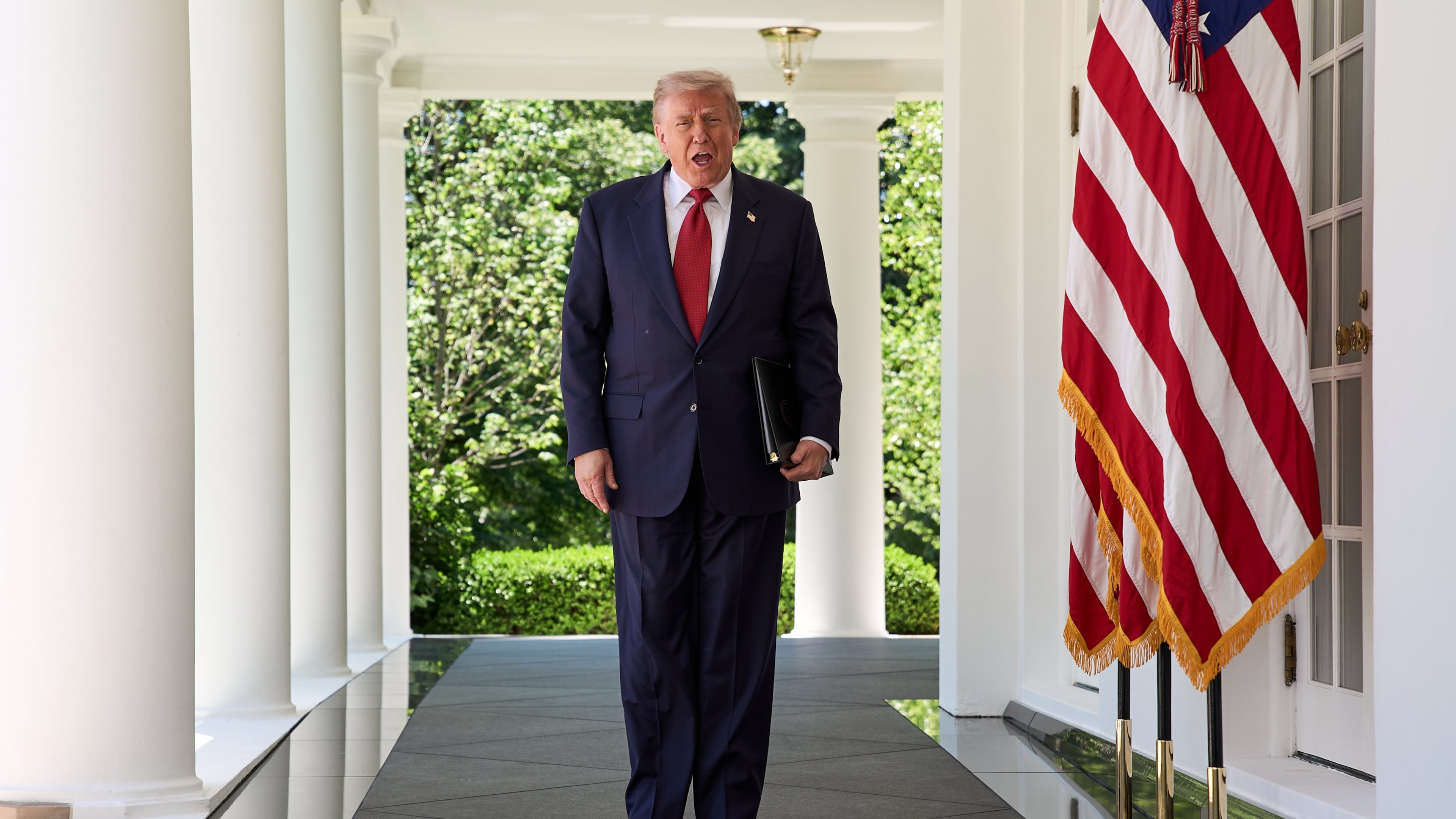 President Donald Trump walks through the Colonnade of the White House as he arrives to attend a luncheon for mothers Friday, May 8, 2026, in the Rose Garden of the White House, in Washington. (AP Photo/Jacquelyn Martin)