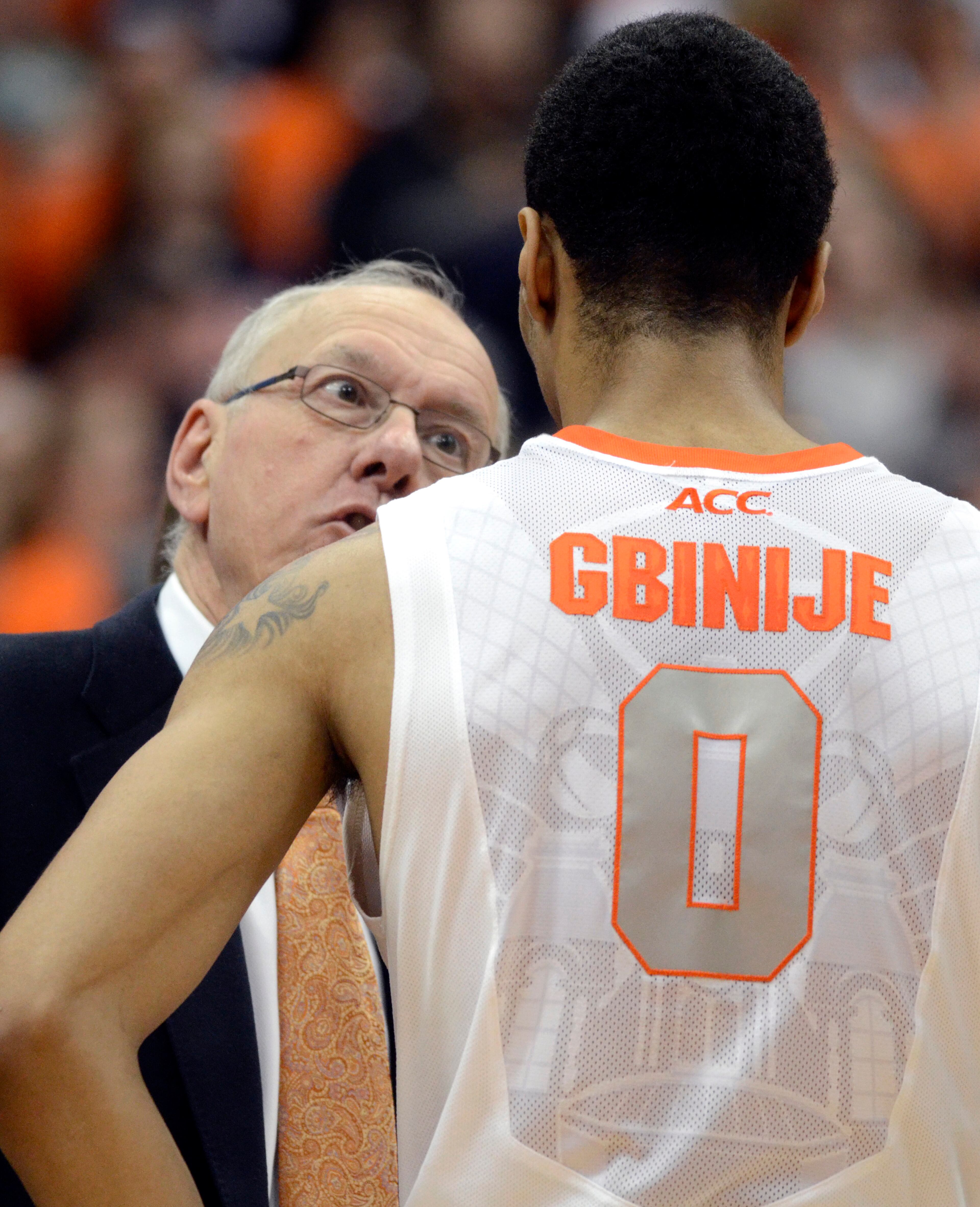 Syracuse head coach Jim Boeheim speaks to Michael Gbinije during a time out against Georgia Tech during the second half of an NCAA college basketball game in Syracuse, N.Y., Tuesday, March 4, 2014. Georgia Tech won 67-62.
