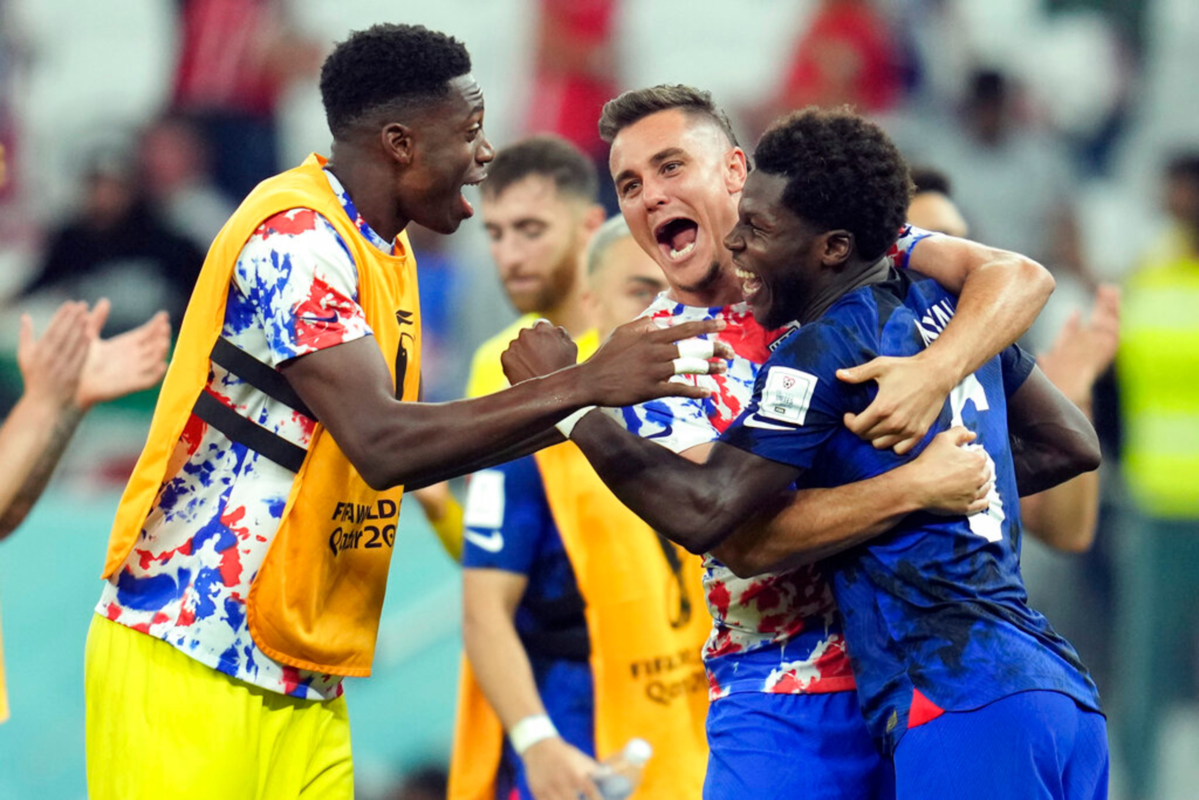 United States' Yunus Musah, right, Aaron Long, center, and United States' goalkeeper Sean Johnson celebrate after defeating Iran in the World Cup group B soccer match between Iran and the United States at the Al Thumama Stadium in Doha, Qatar, Tuesday, Nov. 29, 2022. (AP Photo/Ashley Landis)